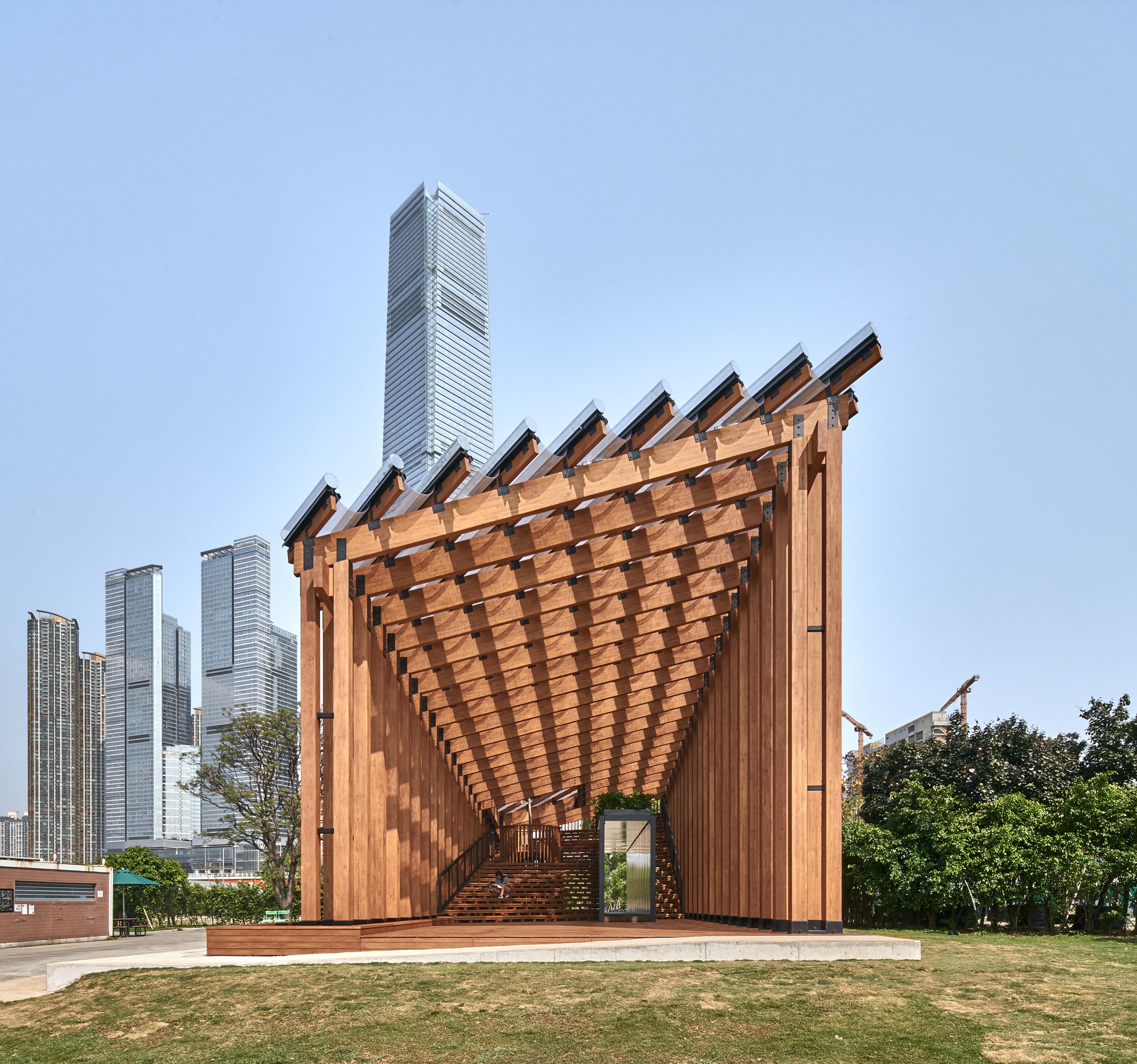 Pavilion structure in daylight with buildings in background
