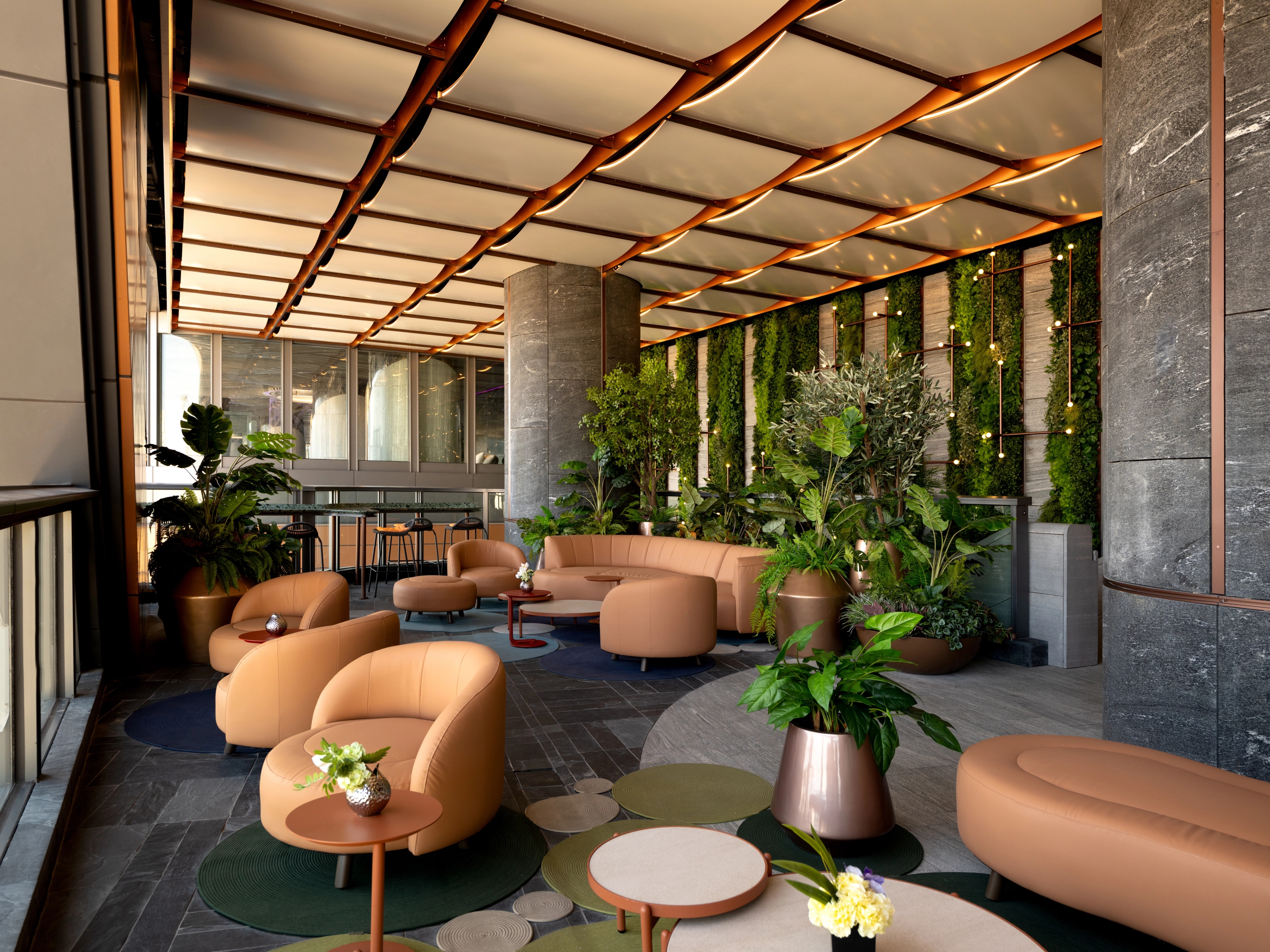 Luxury lounge area with ripple ceiling and green wall