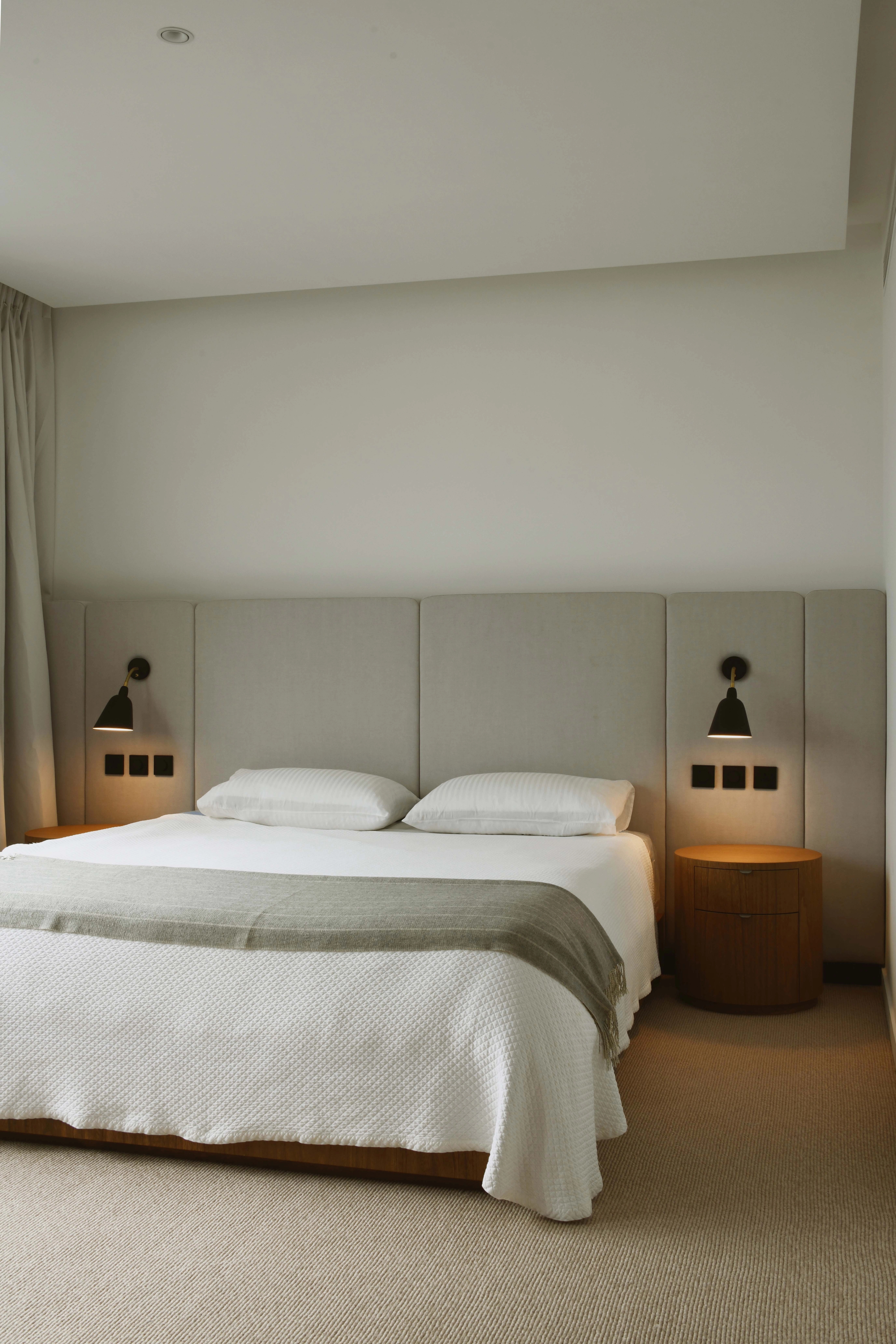 master bedroom with upholstered headboard