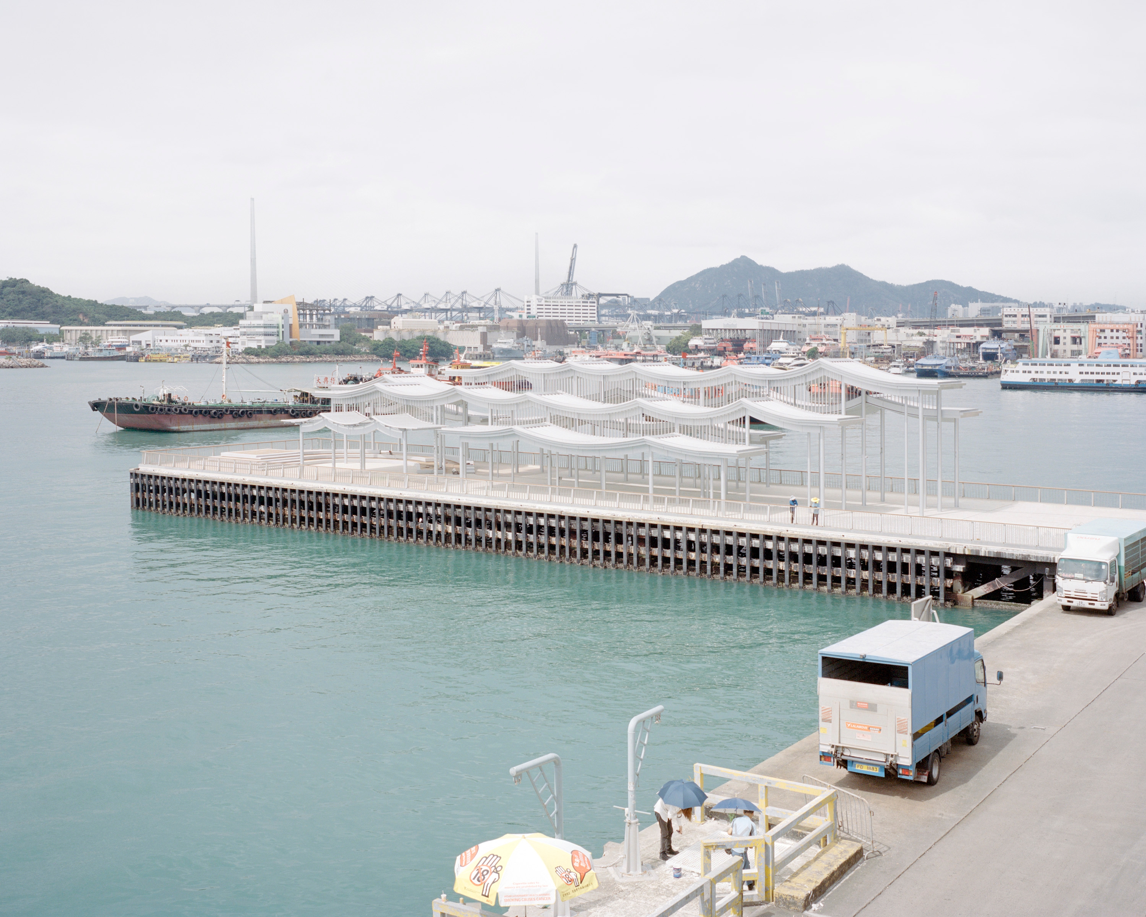 Pier canopy with boats in the background