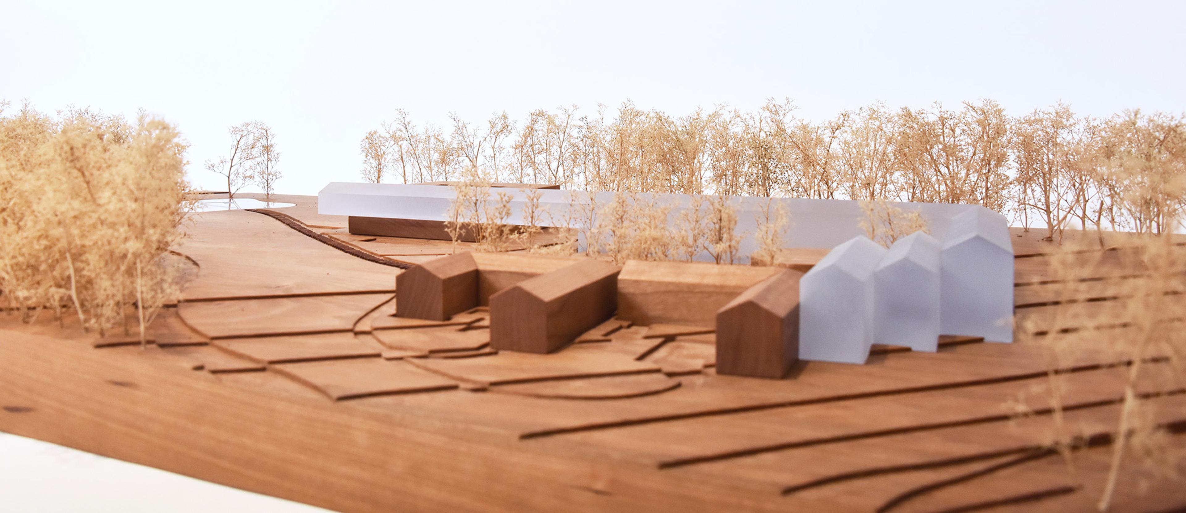 architectural model of modern structure on a hill within a forest