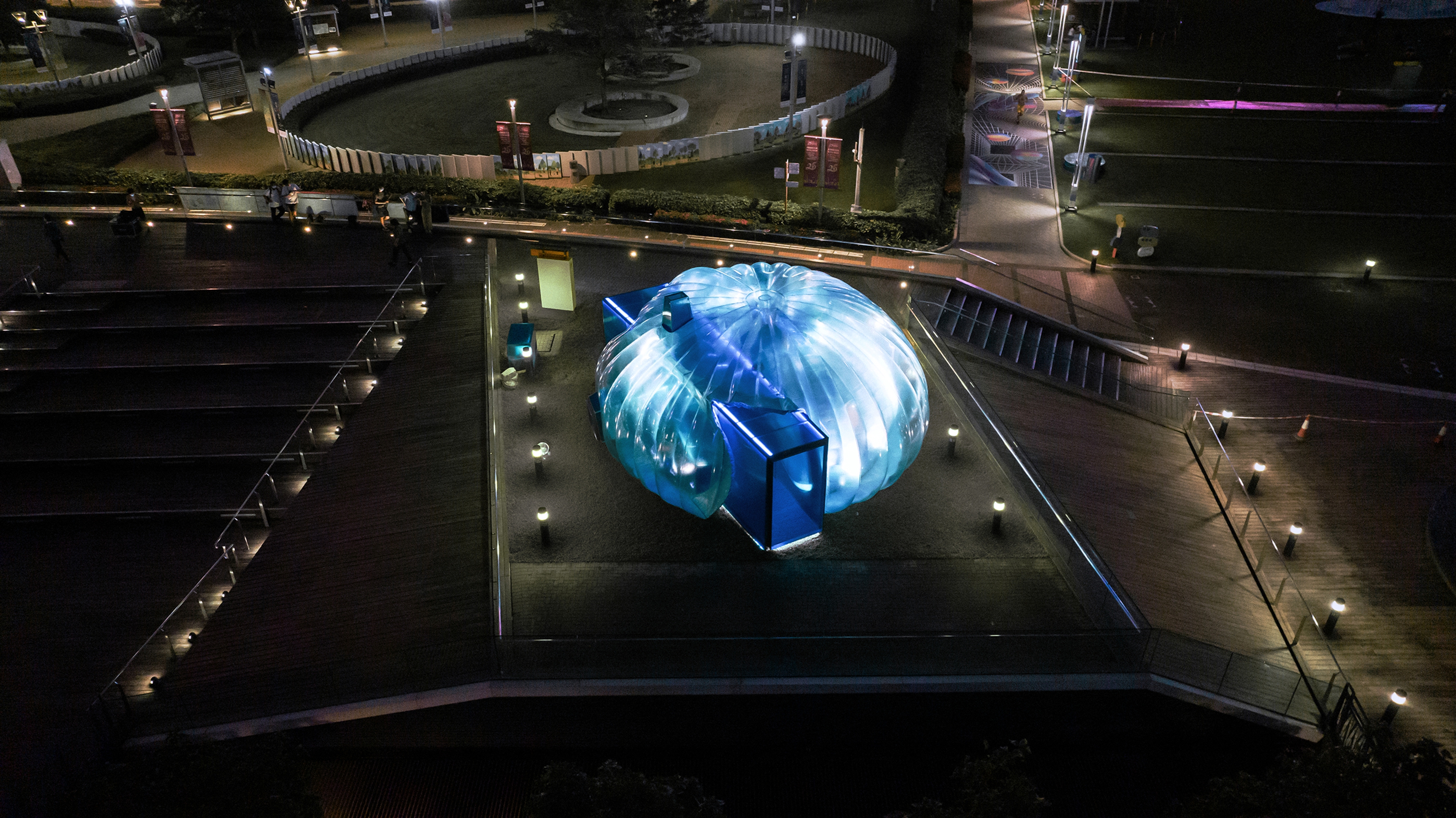 Temporary bubble art installation structure on Hong Kong harbour front at night