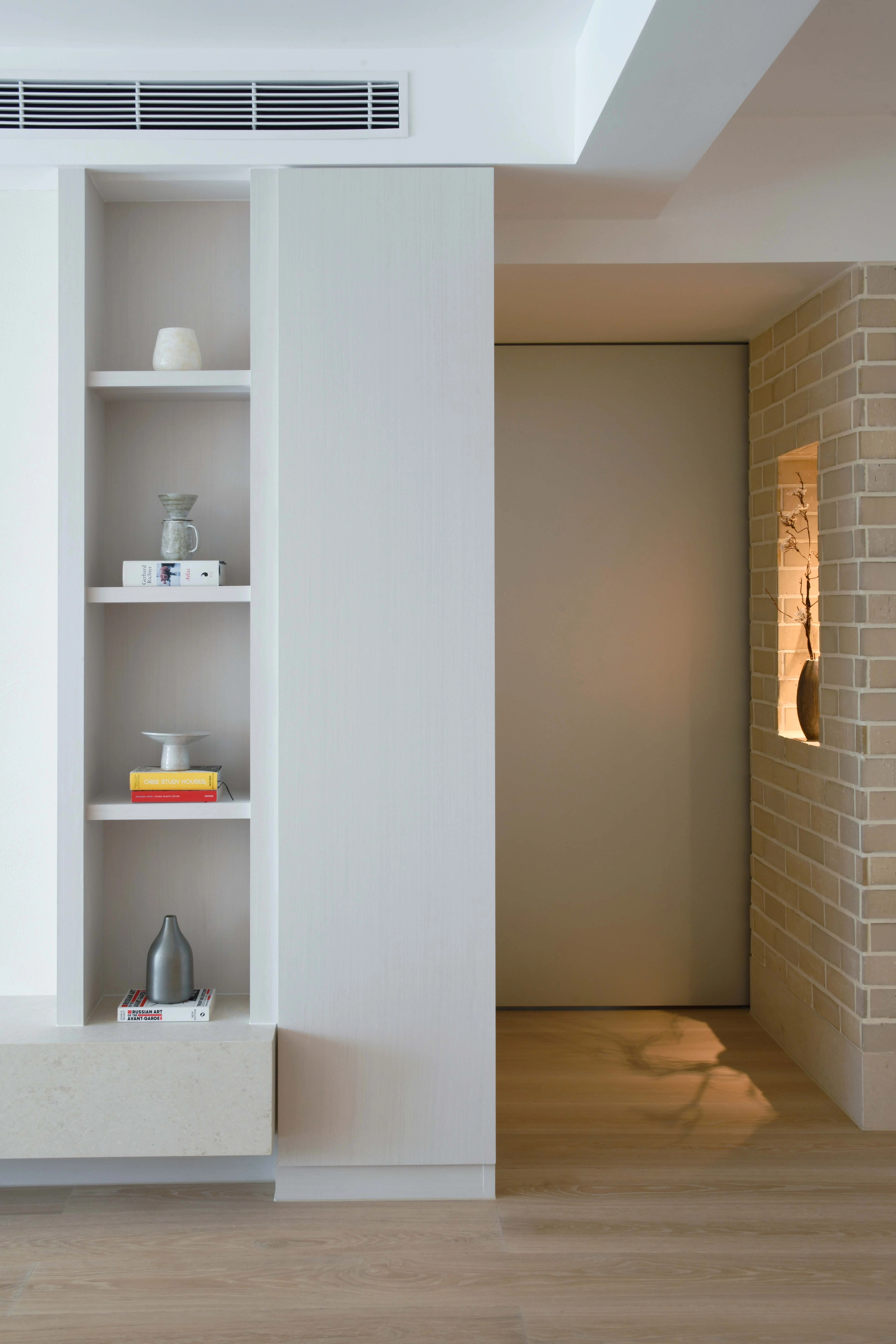 brick wall with niche and silver door