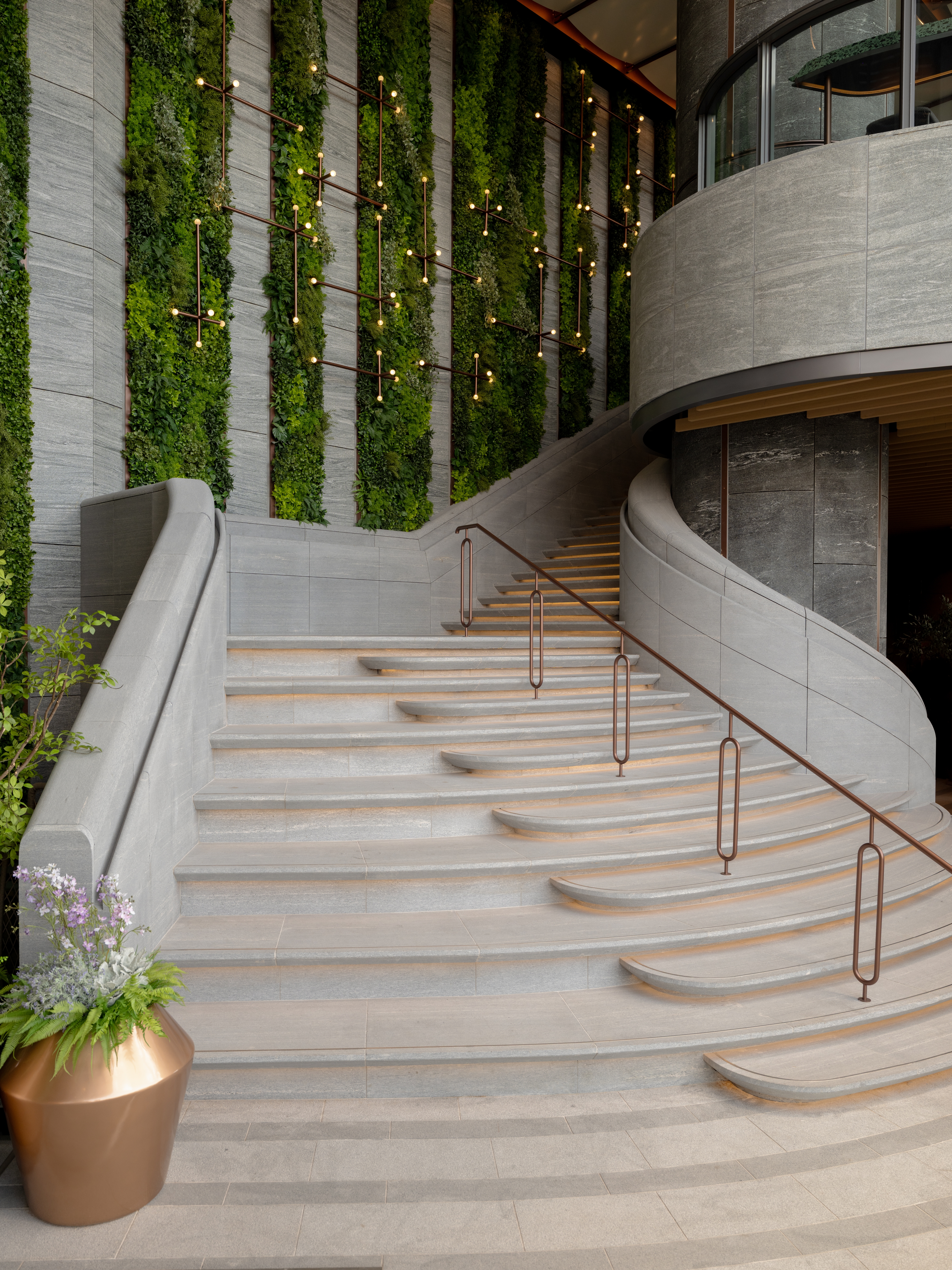 curved stone stair with green wall