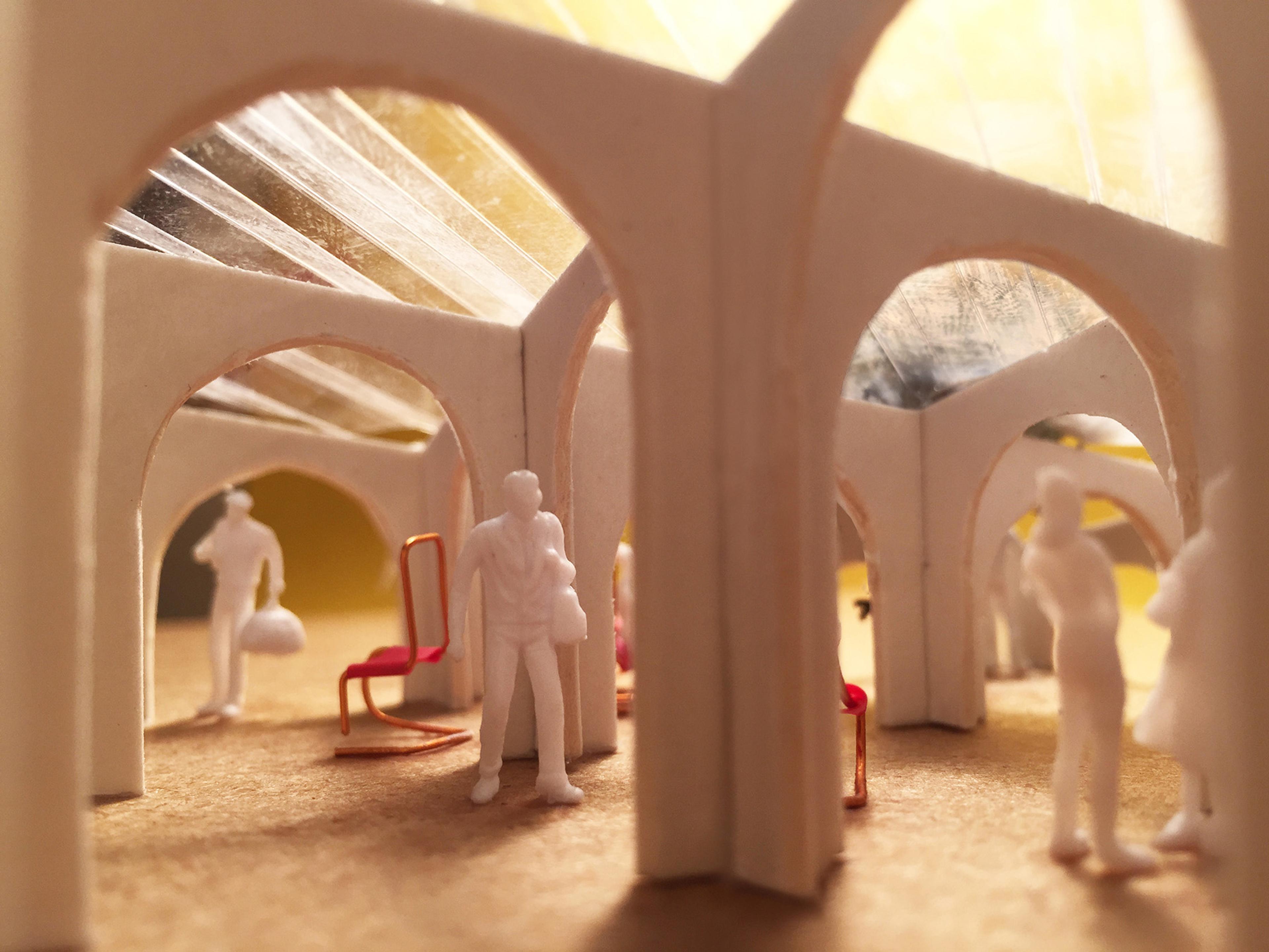 Inside architectural model of pavilion with chairs and people