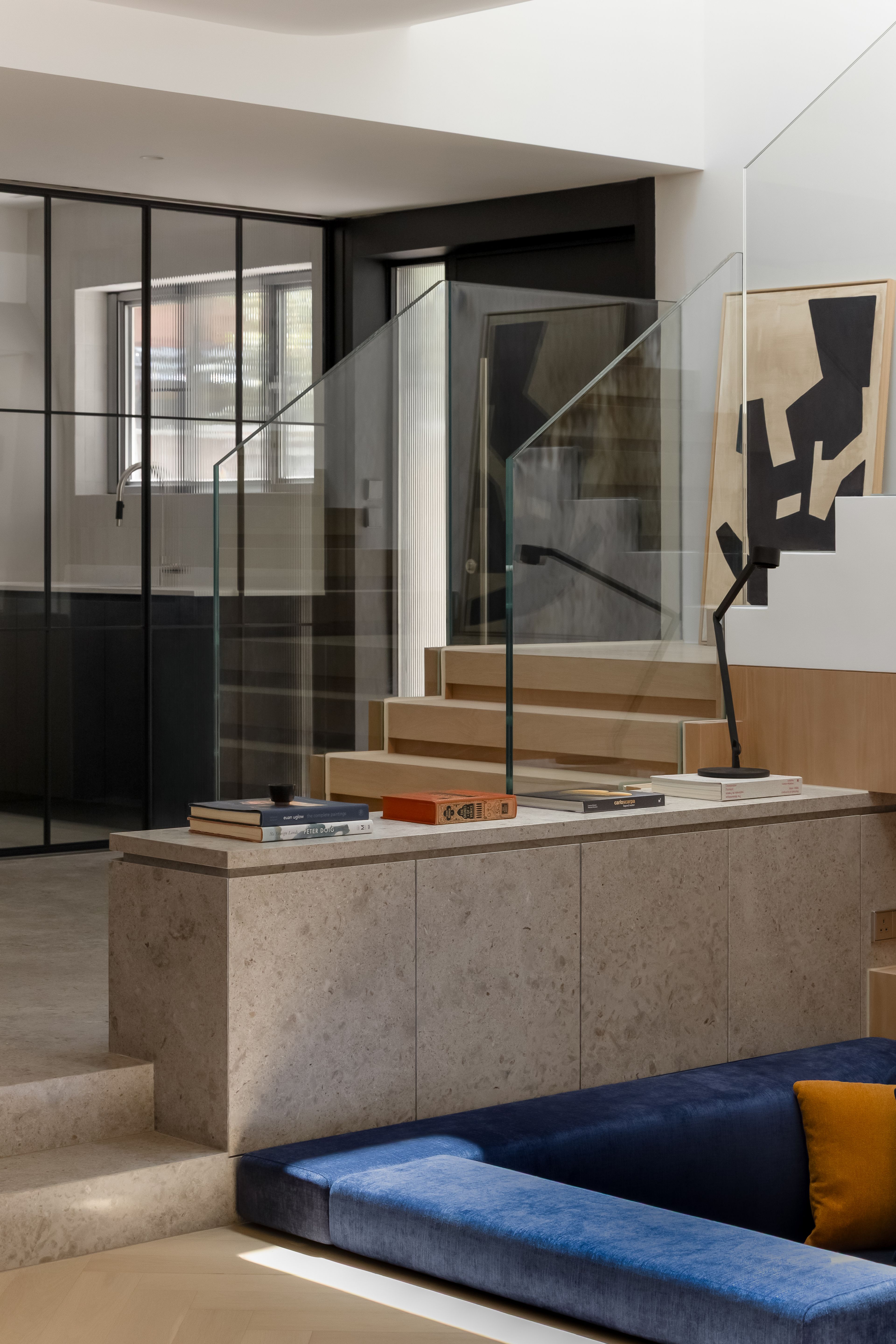 Entrance door with stone cabinet and blue sunken sofa
