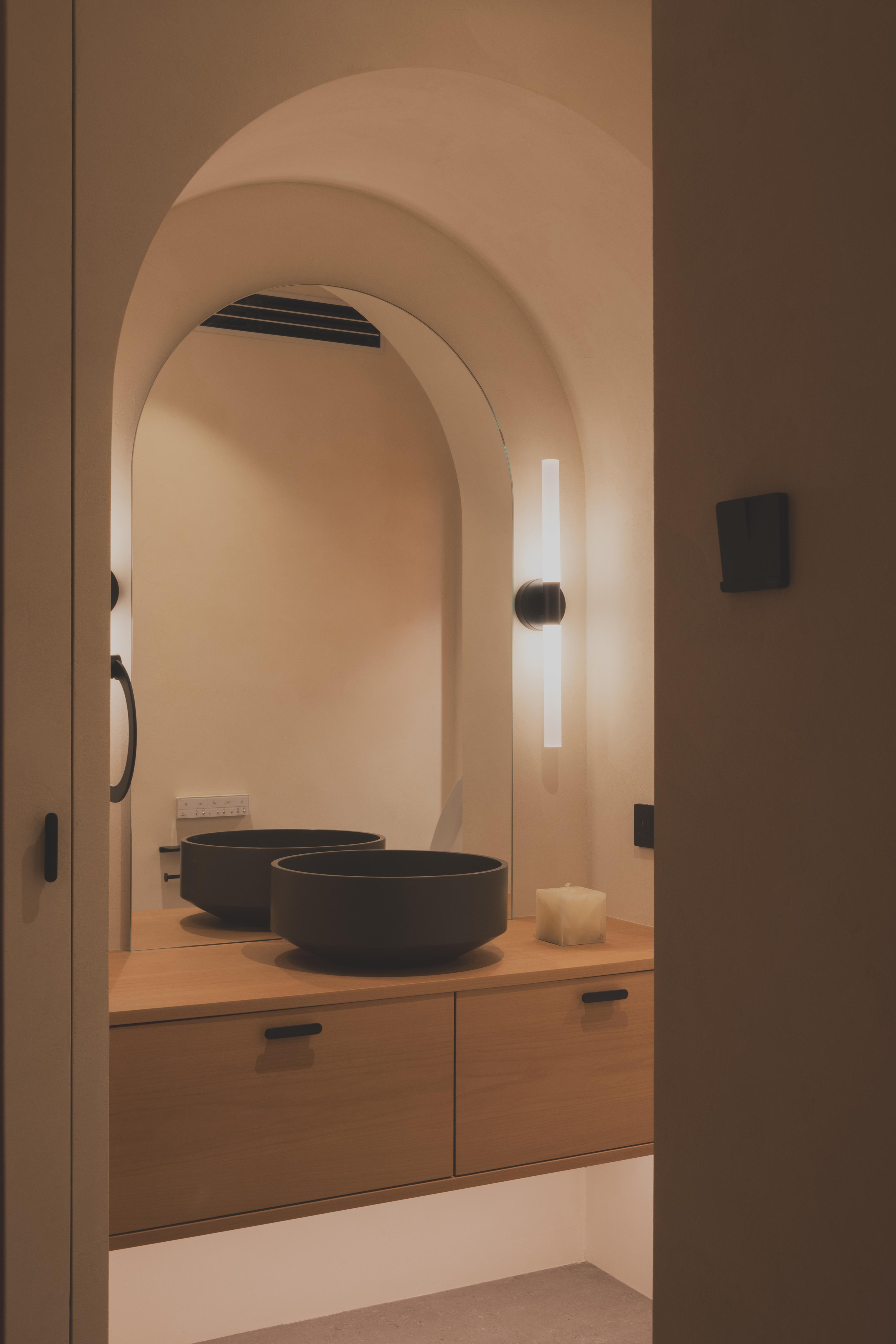 Powder room with arch niche and mirror