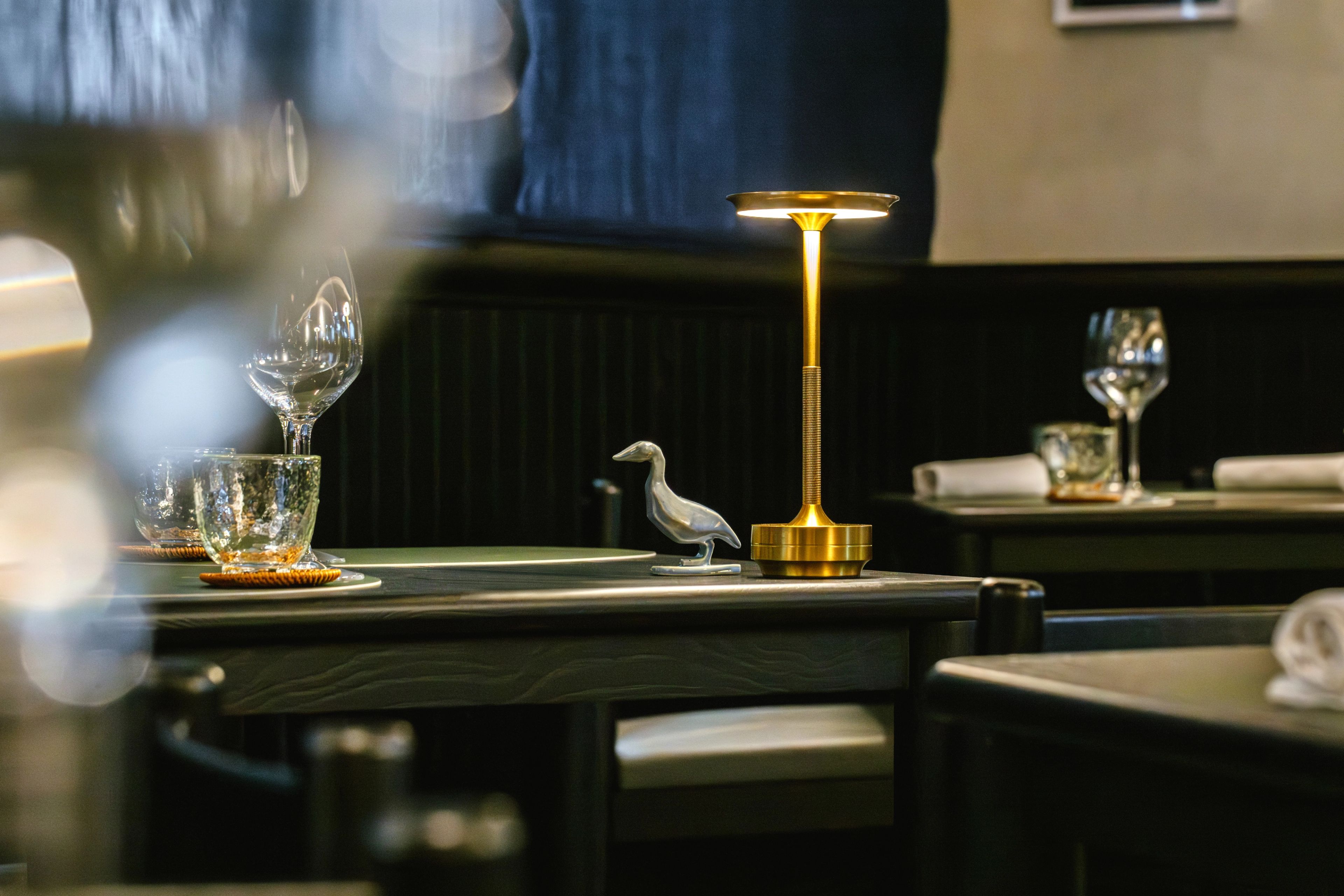 Black wood table with gold table light and ceramic duck