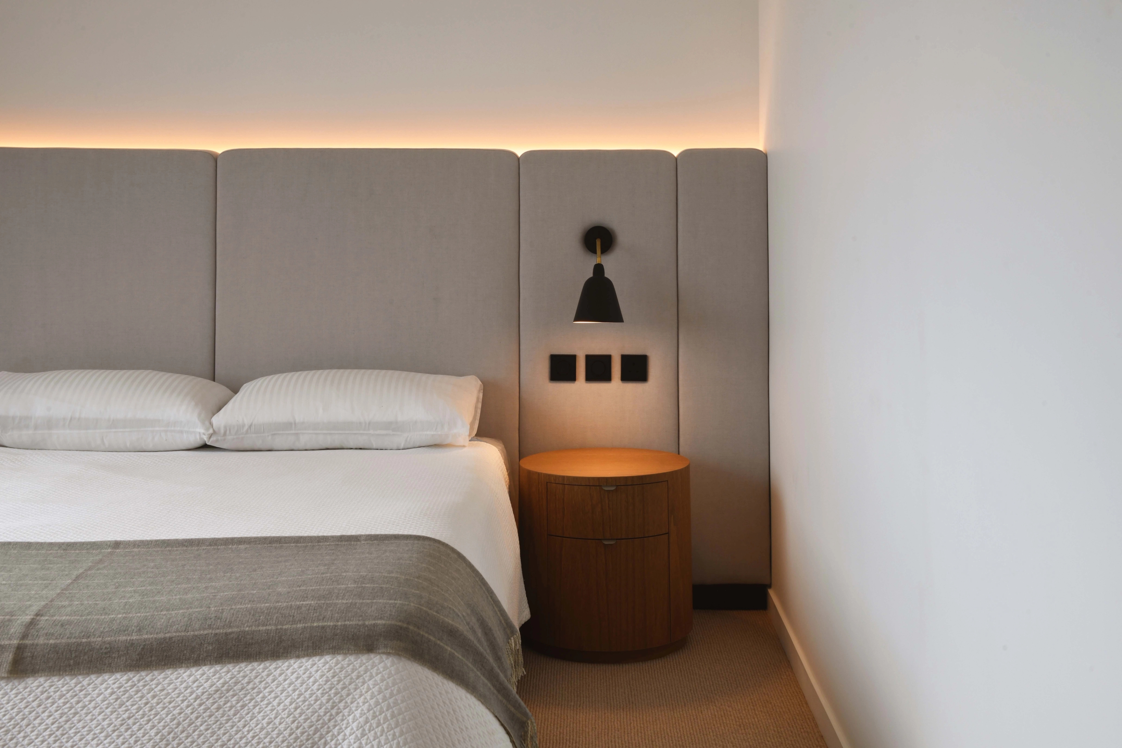 upholstered headboard with midcentury bedside light