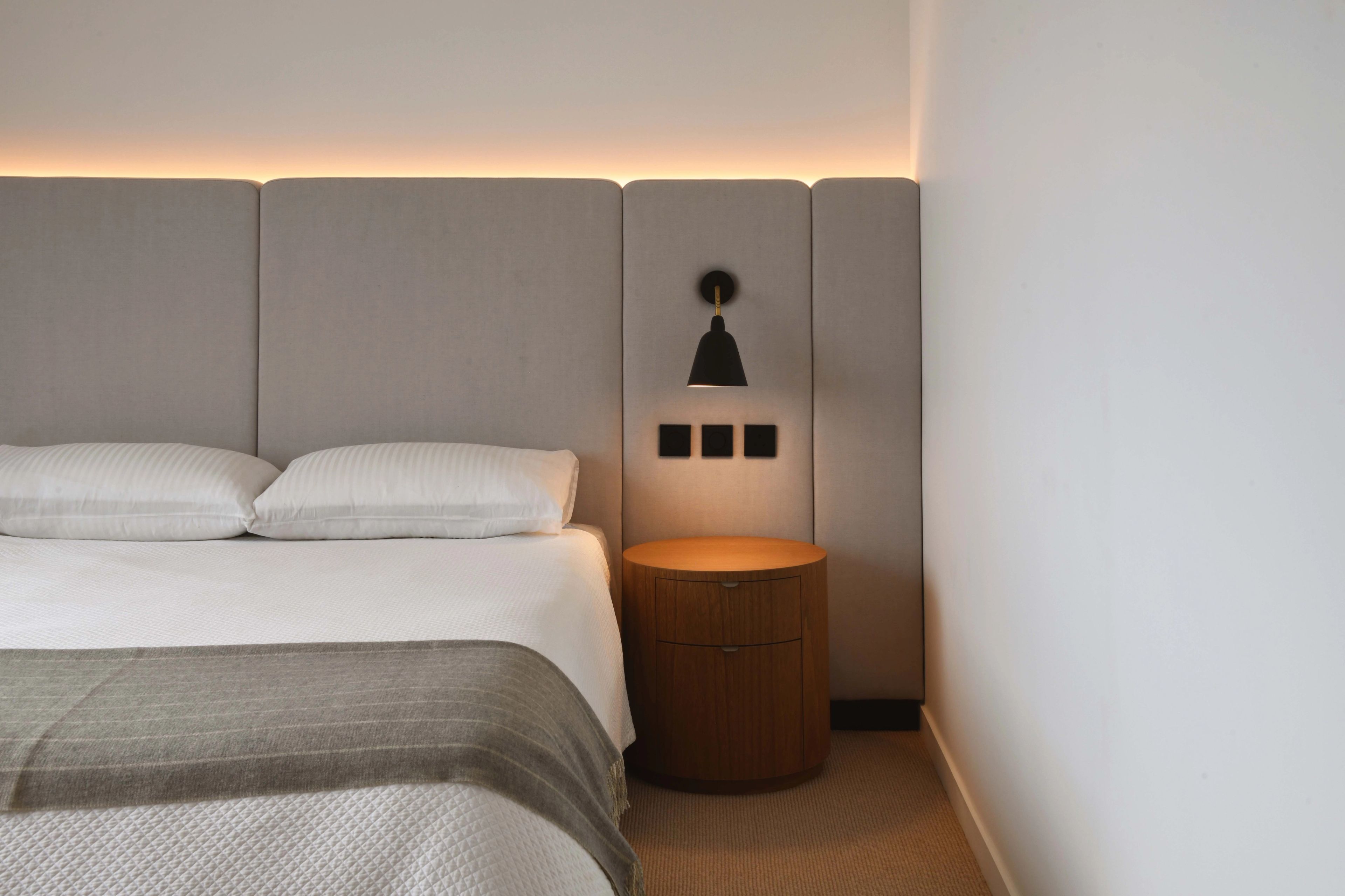 upholstered headboard with midcentury bedside light