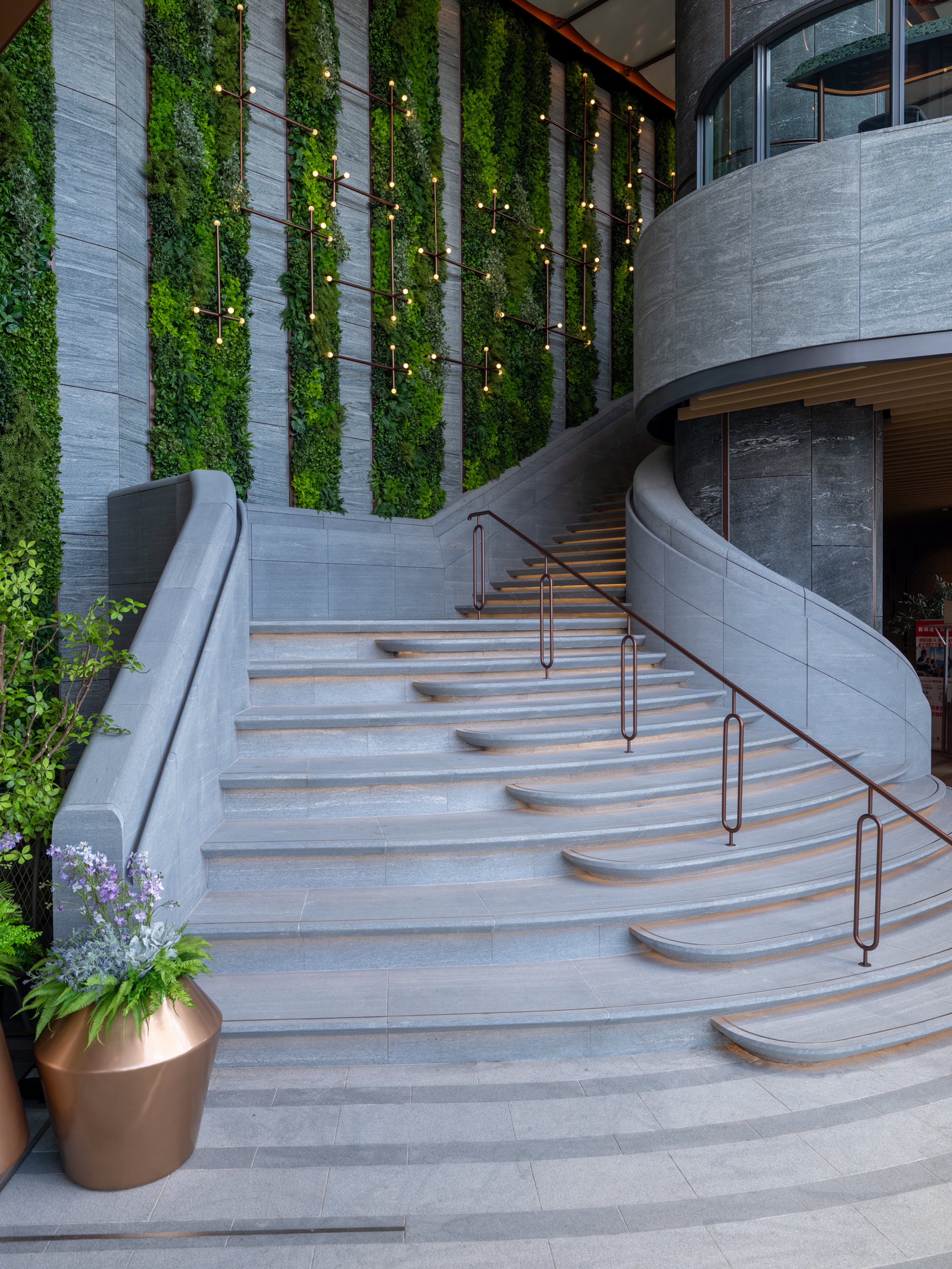curved stone stair with green wall