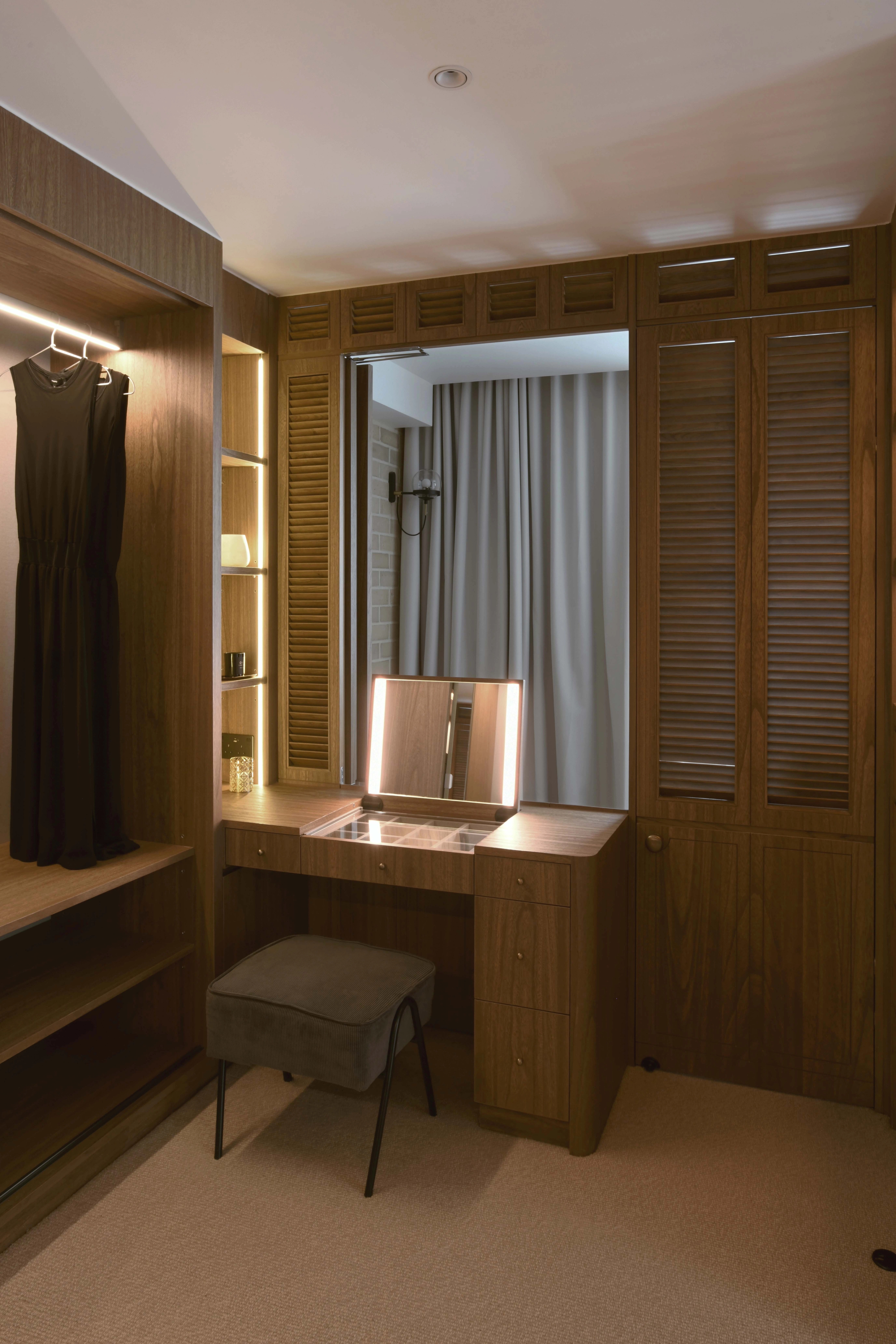 walk in wardrobe with walnut wood and vanity table
