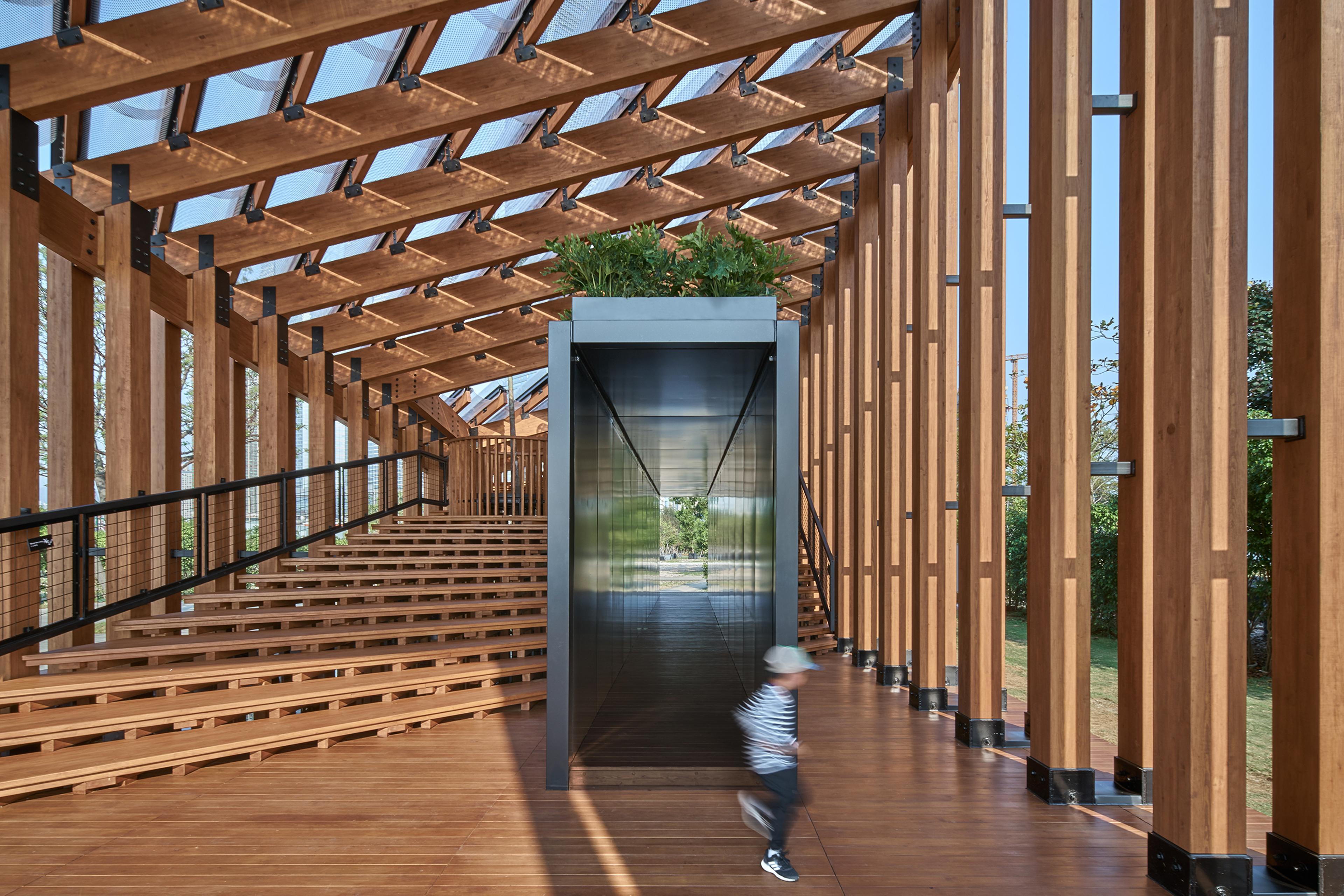 Inside view of Pavilion roof structure in daylight with child playing