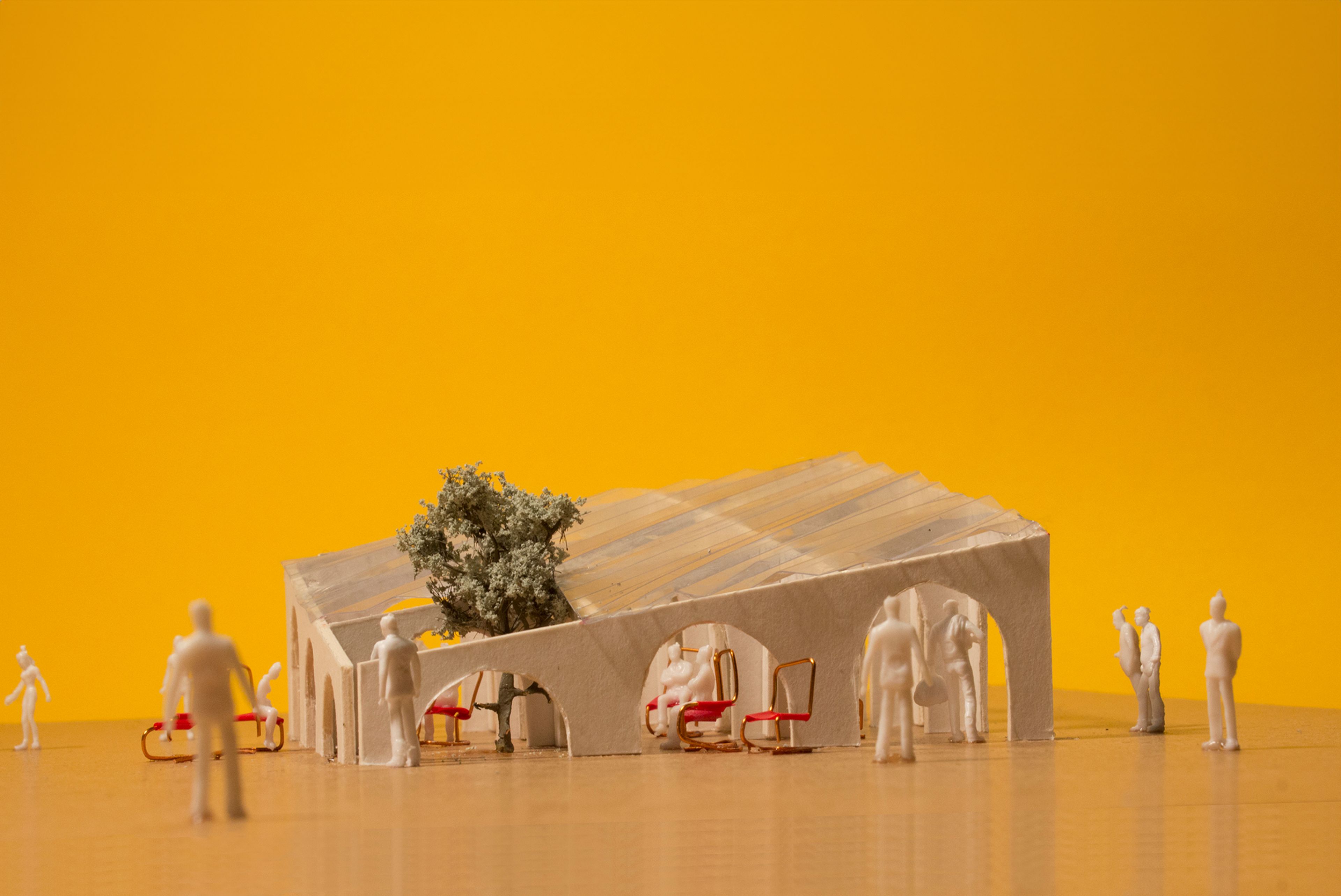 Architectural model of pavilion with chairs and people with a yellow background