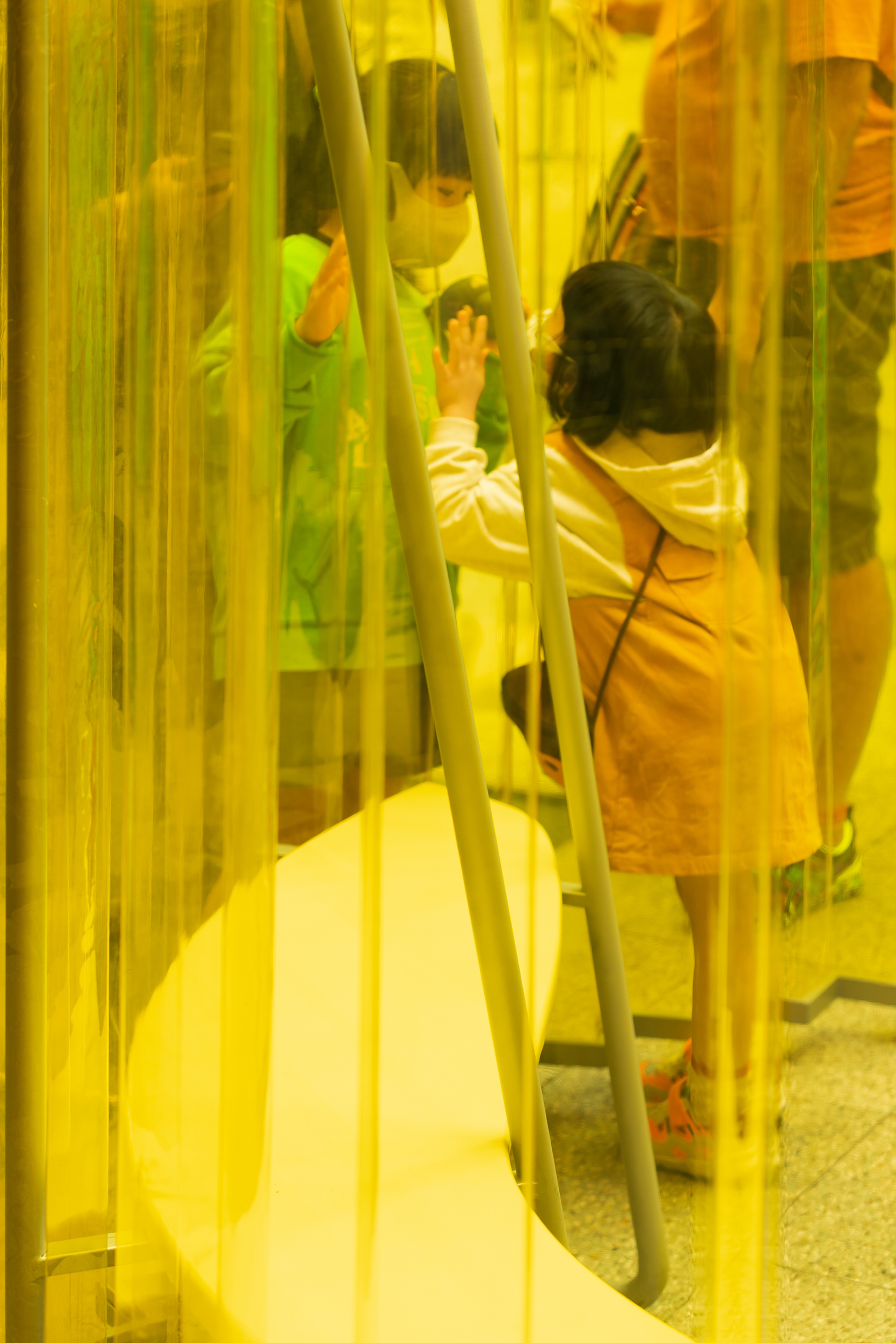 inside view colorful installation inside building courtyard with children playing