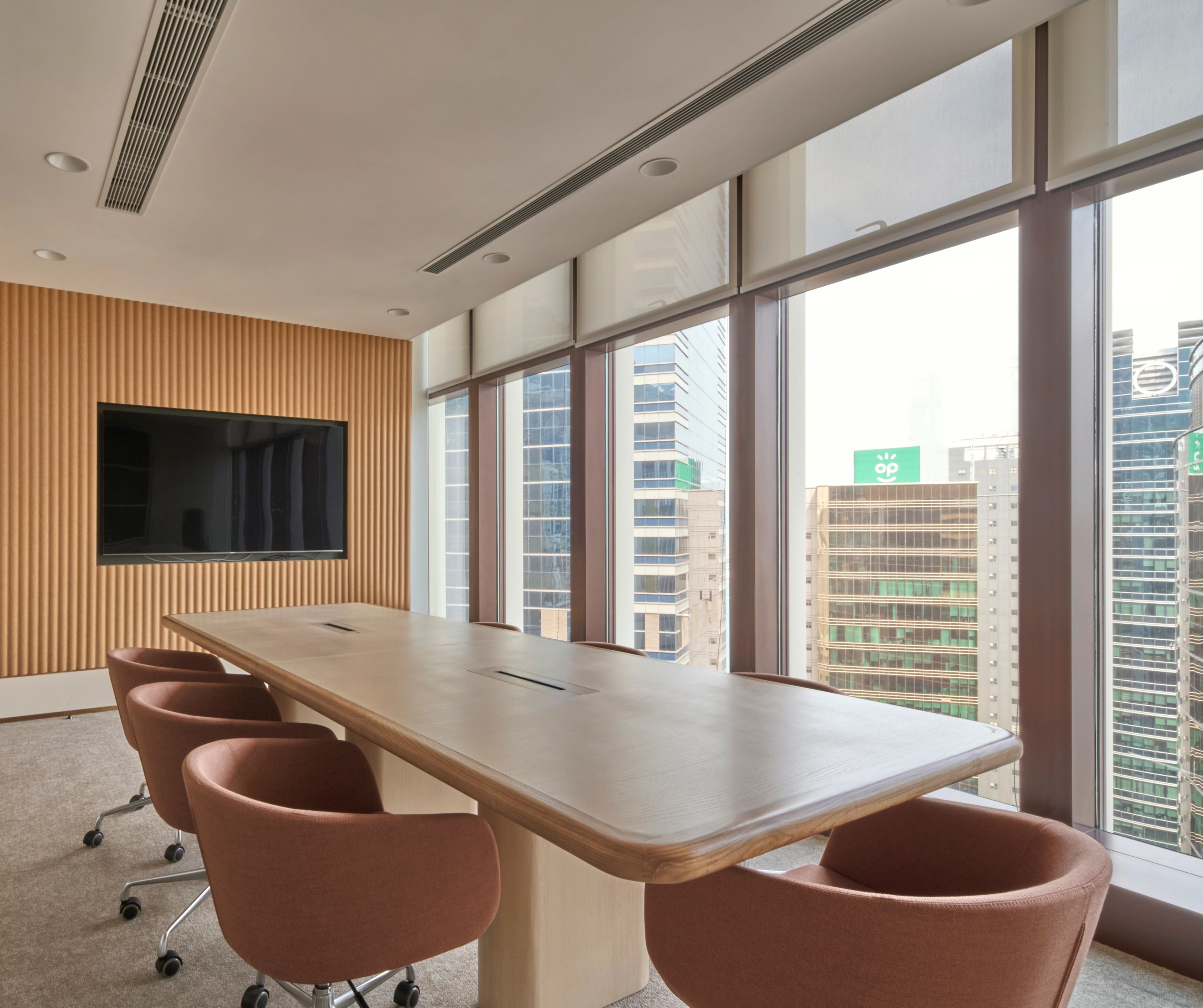 The bright conference room, adorned with panoramic city views.