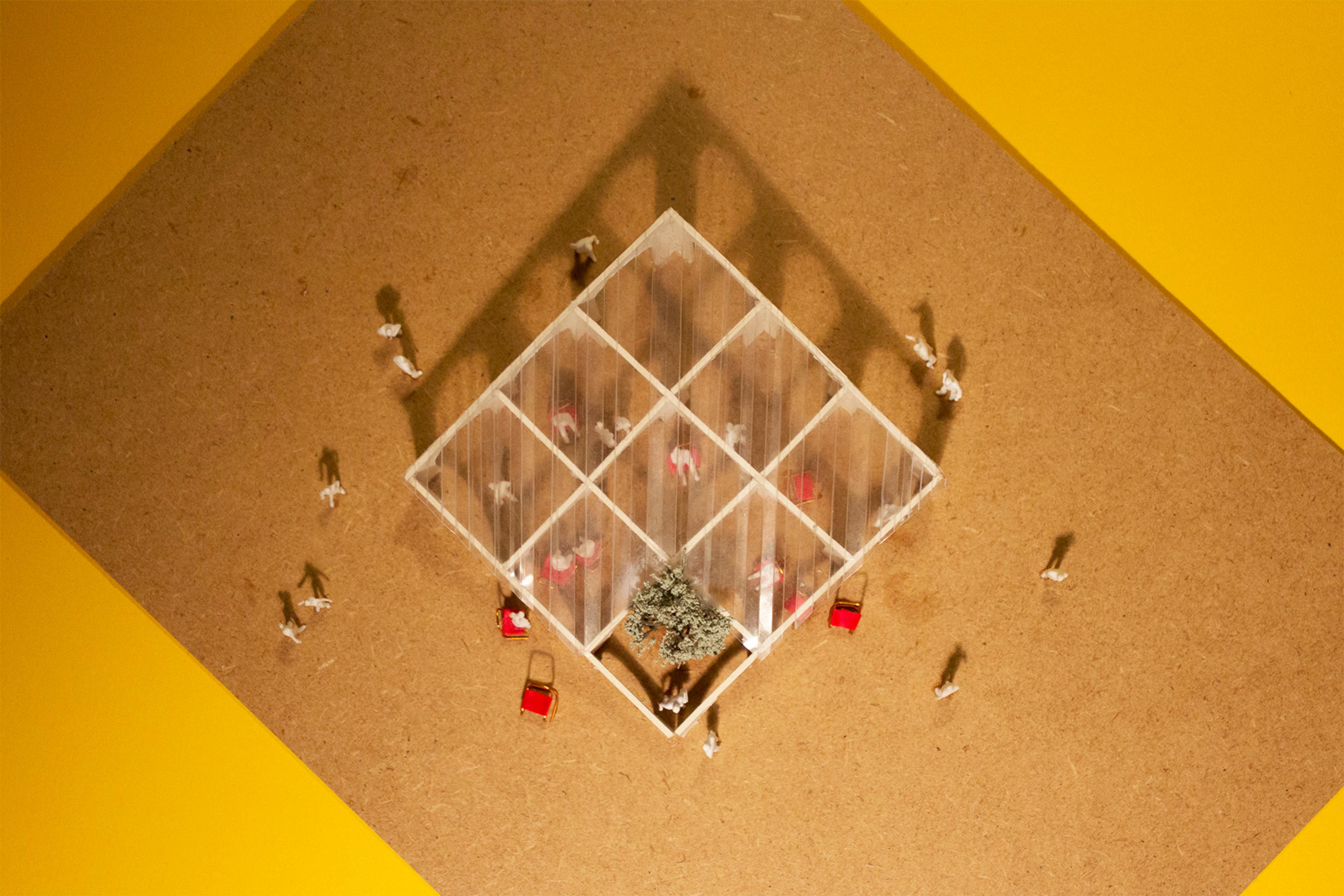Architectural model of pavilion with chairs and people with a yellow background top down view