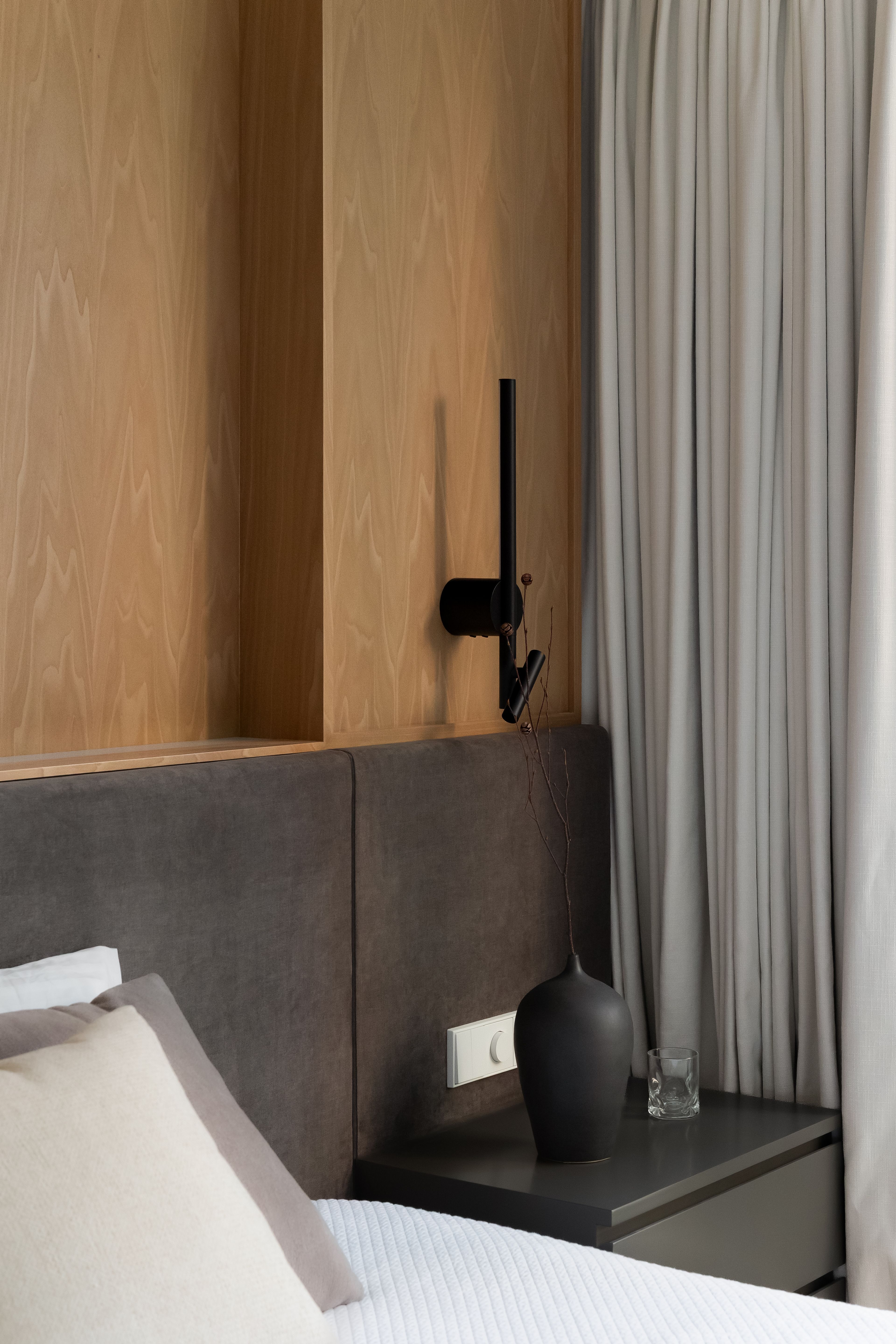 Custom wood bedside cabinet with wall luminaire