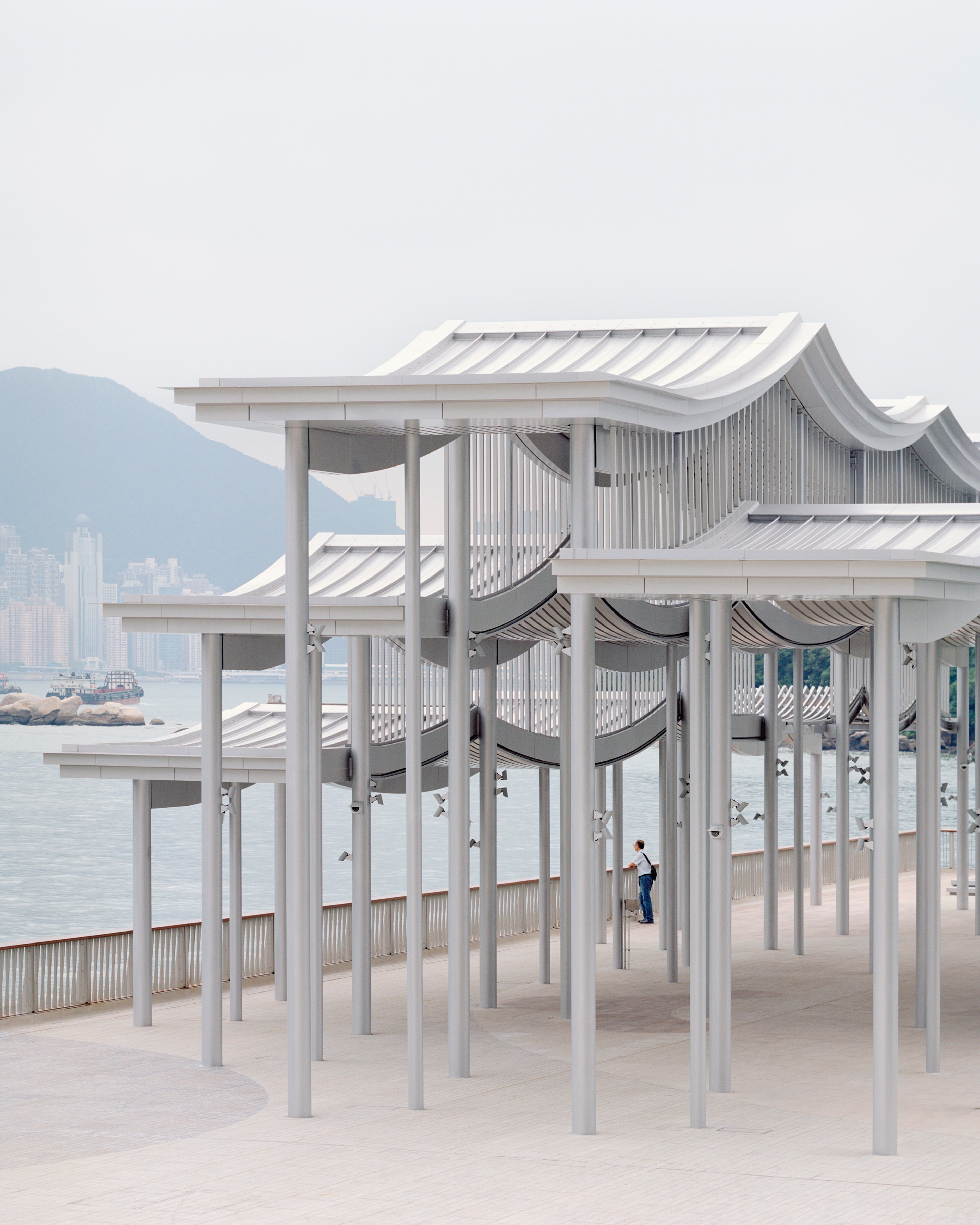 Silver undulating roof of pier canopy with standing seam