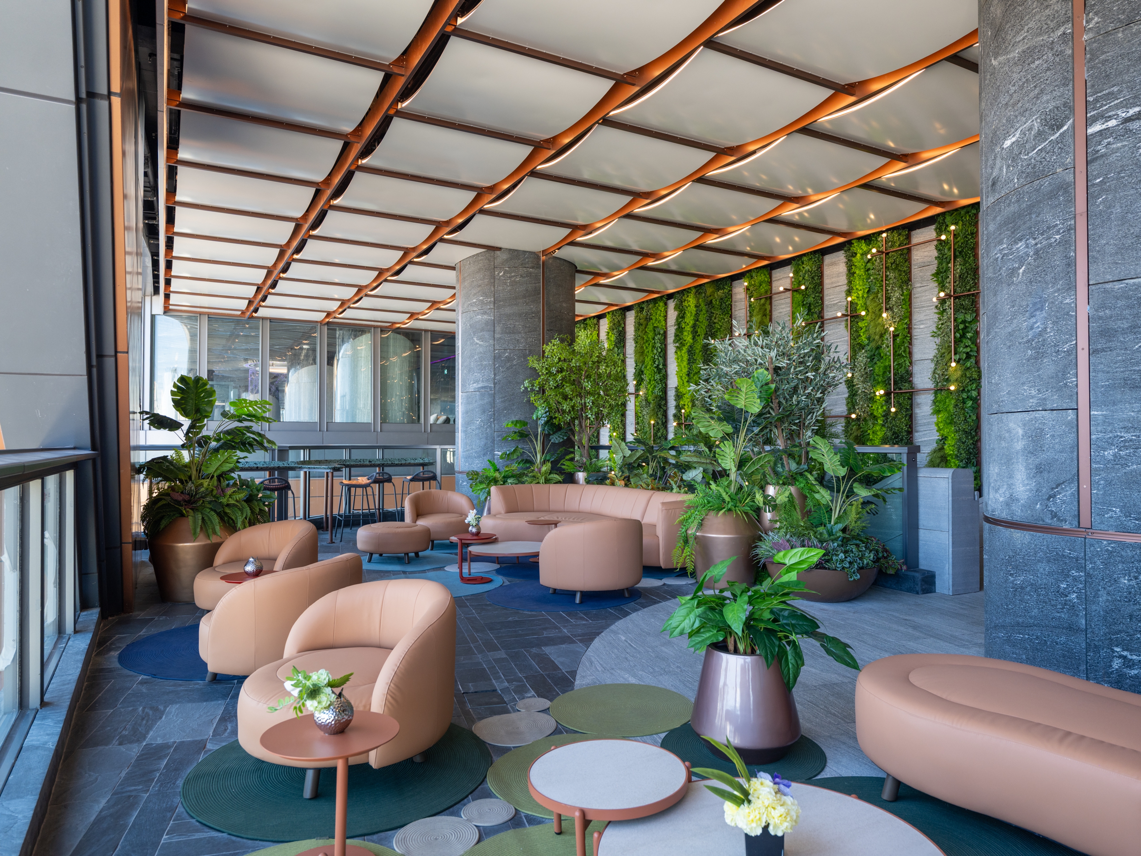 Luxury lounge area with ripple ceiling and green wall