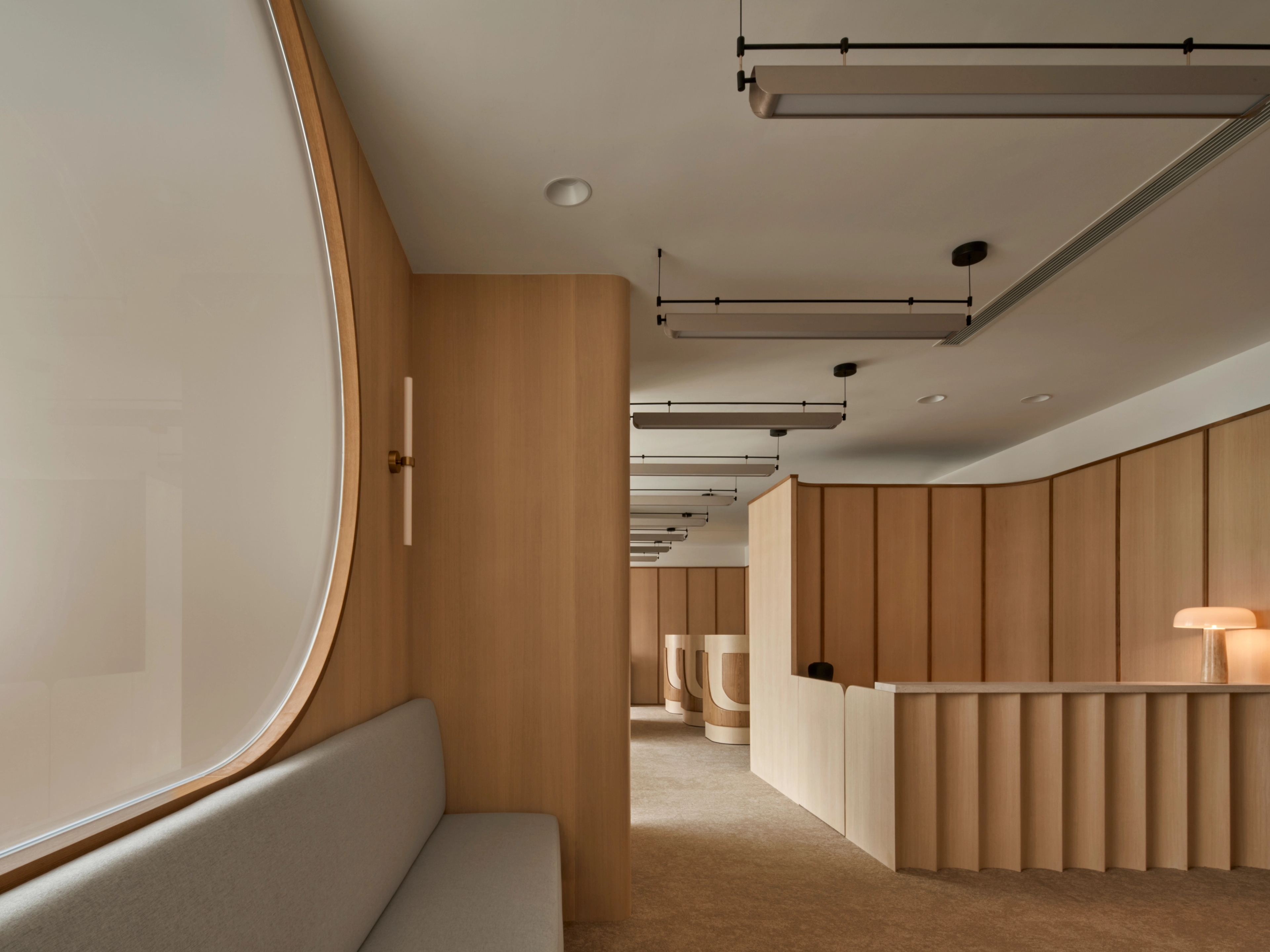 Rounded windows and rhythmic lighting balancing modern design with natural warmth.