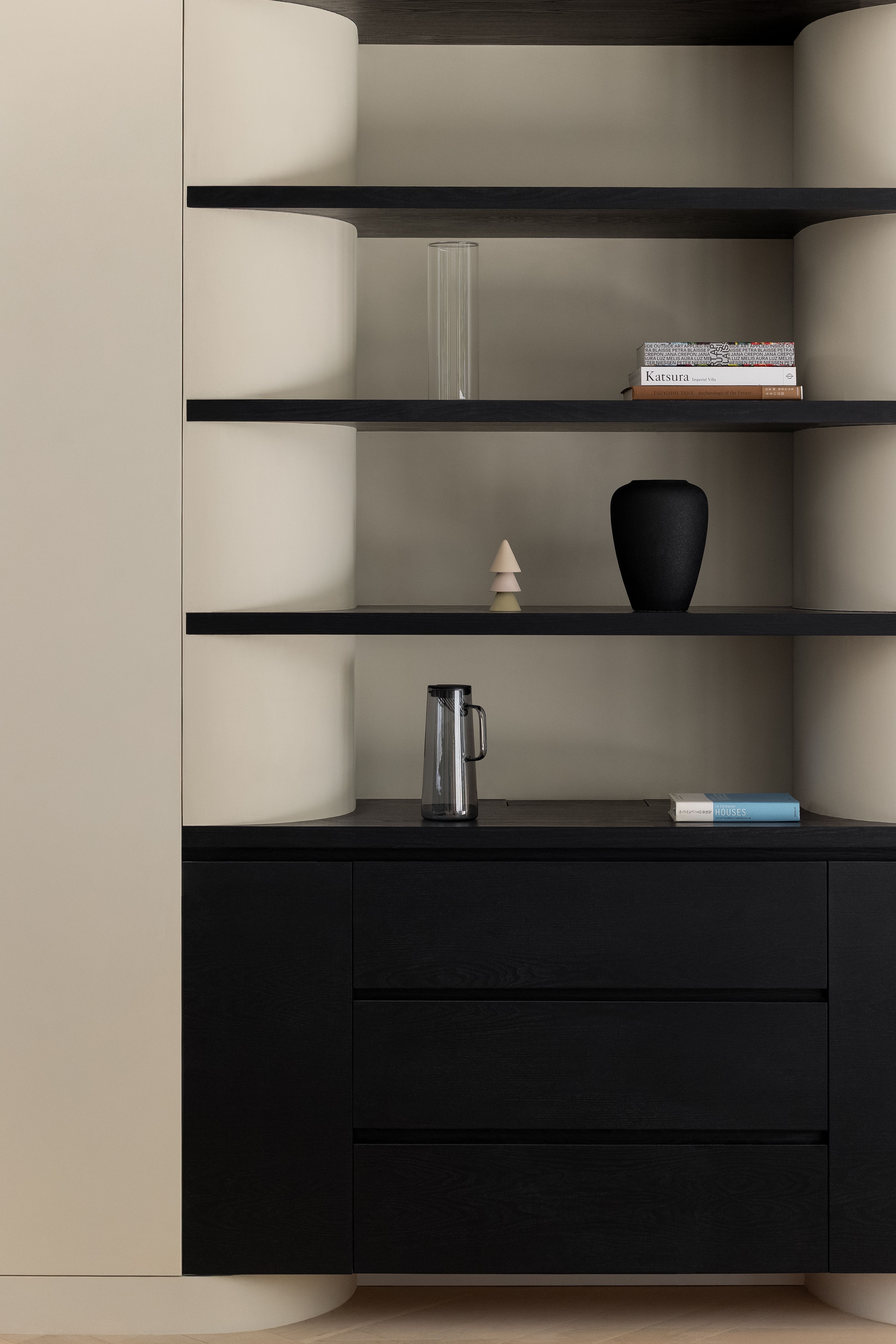 Curved built in joinery with black wood drawers
