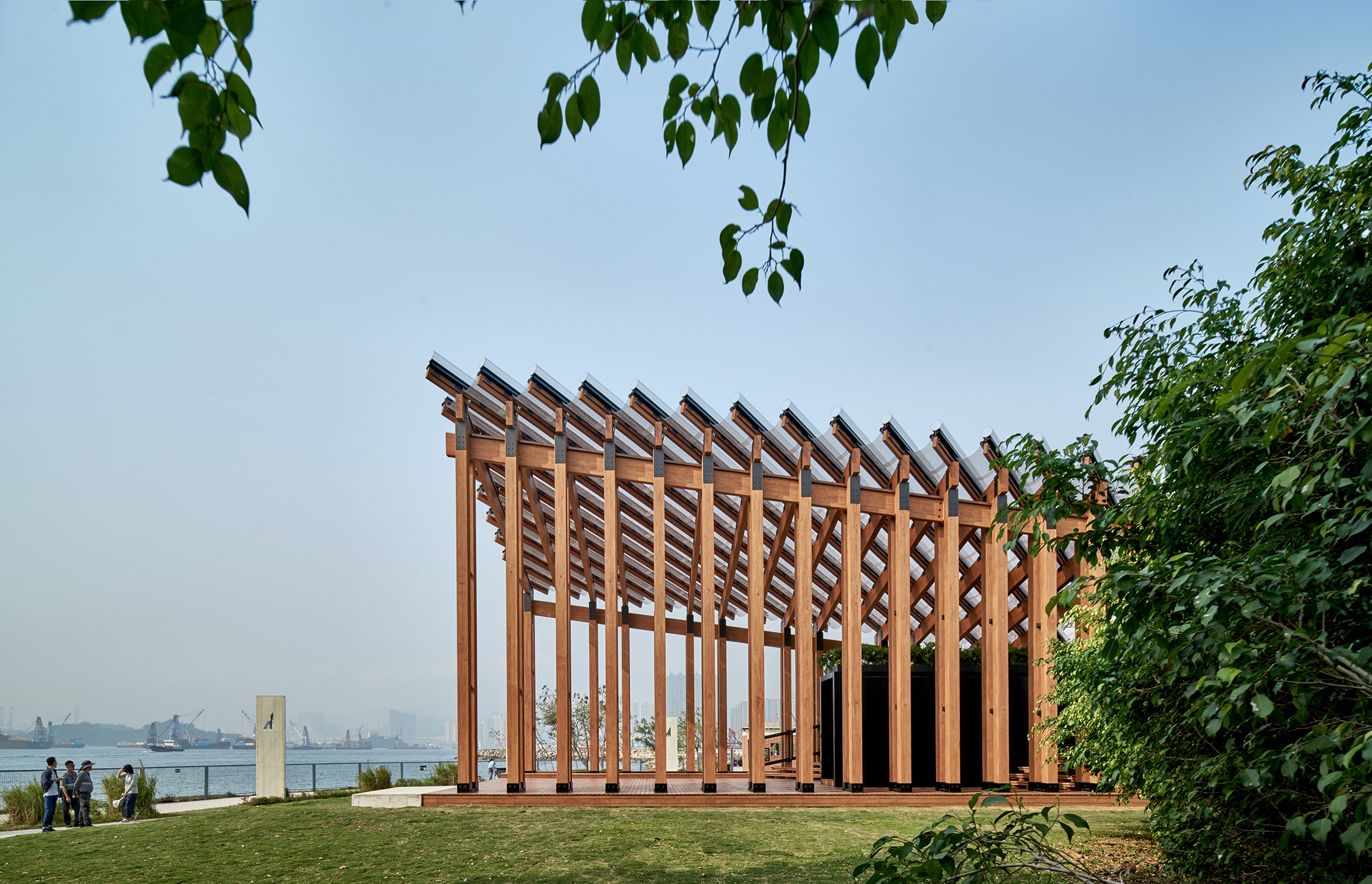 Pavilion in daylight with sky in background and trees along harbourfront 