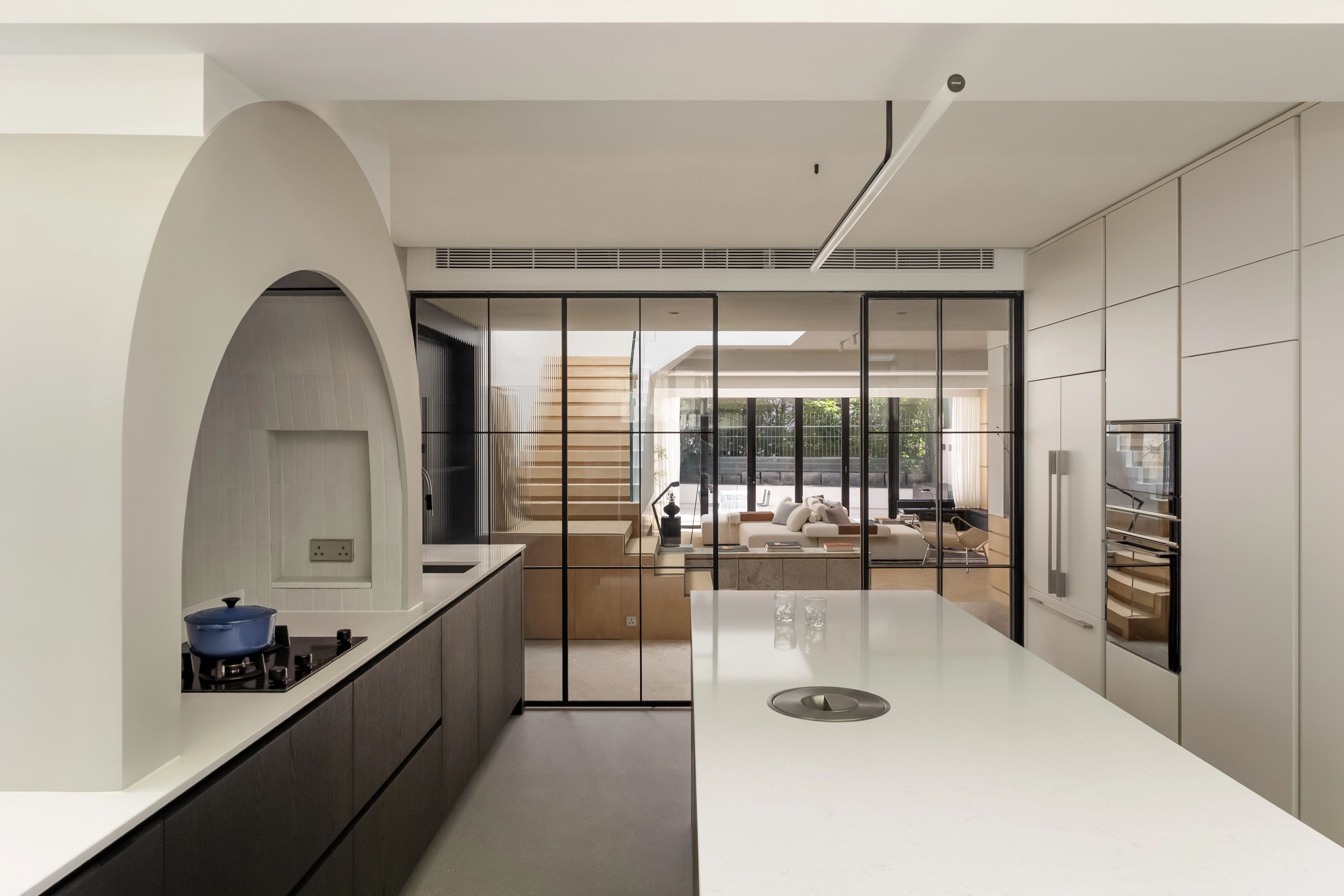 White and black kitchen with arched alcove