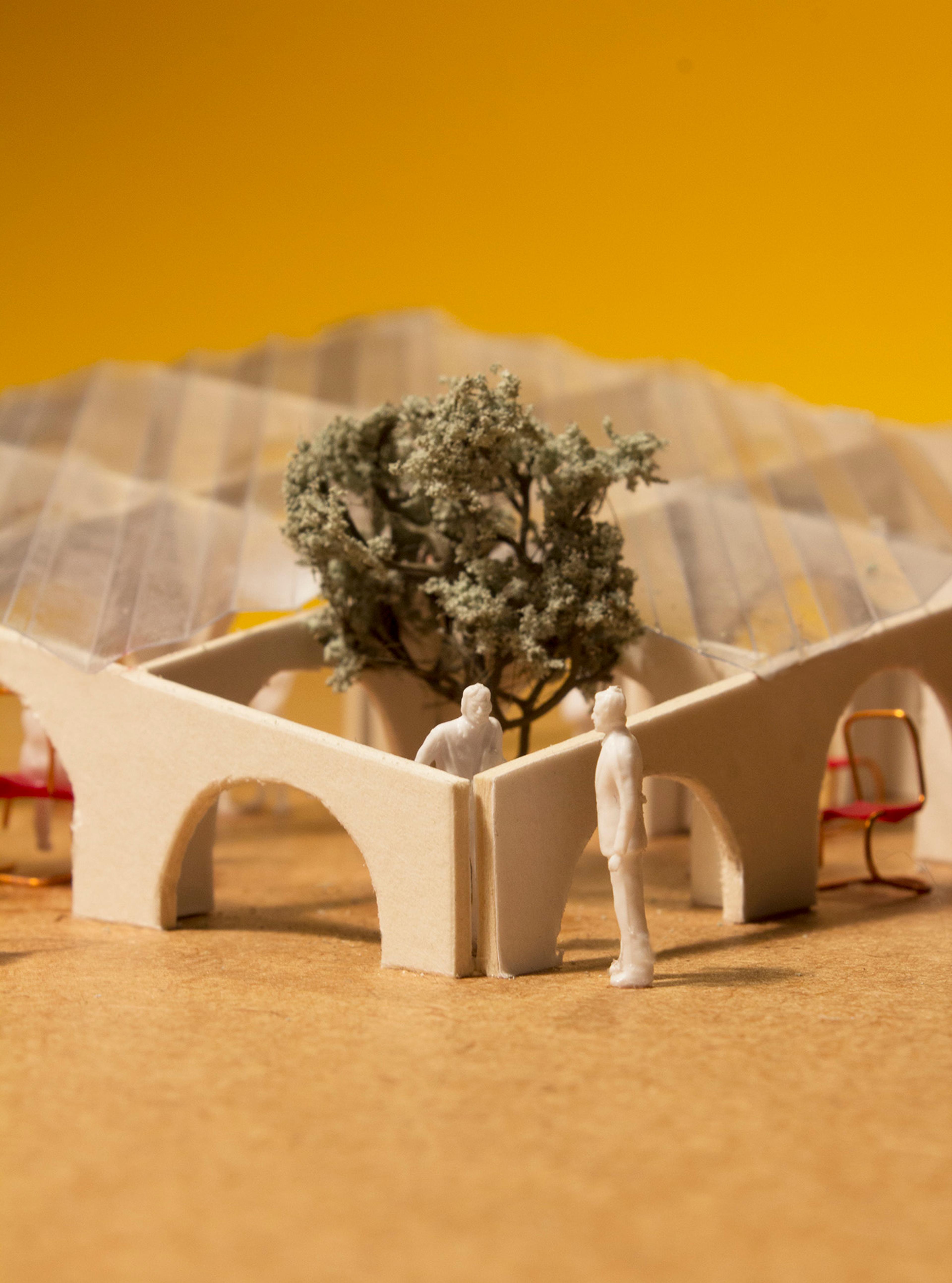 Architectural model of pavilion with chairs and people with a yellow background 