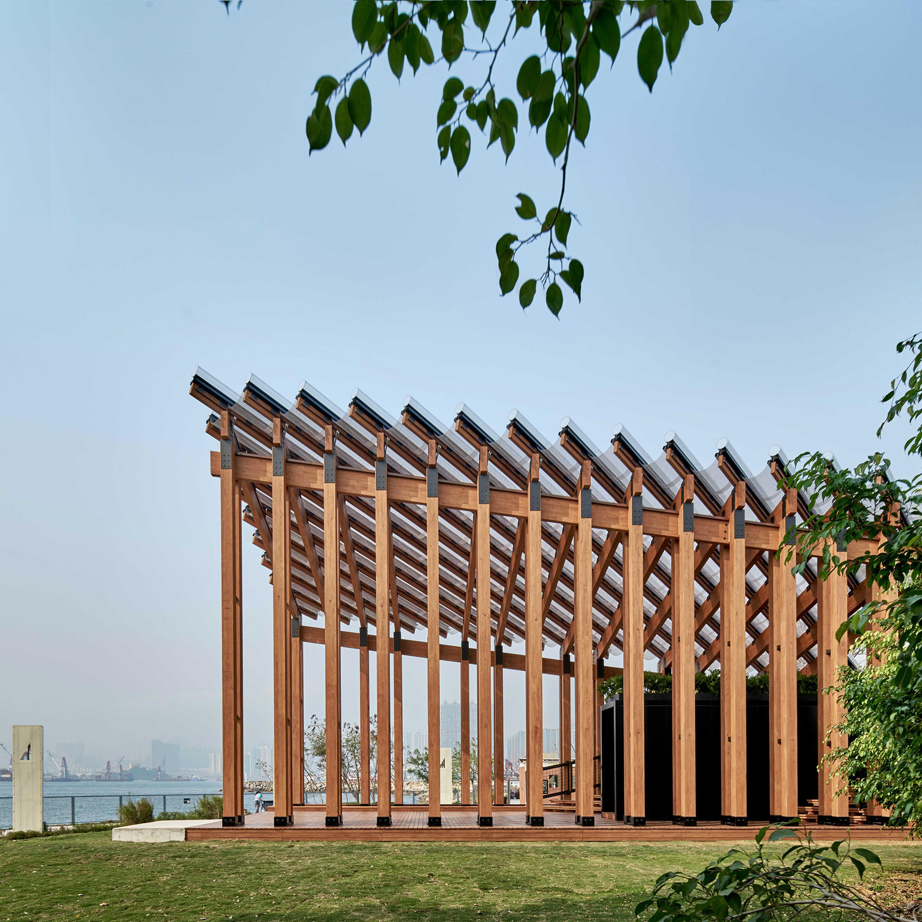 Outdoor pavilion by the harbour in front of trees