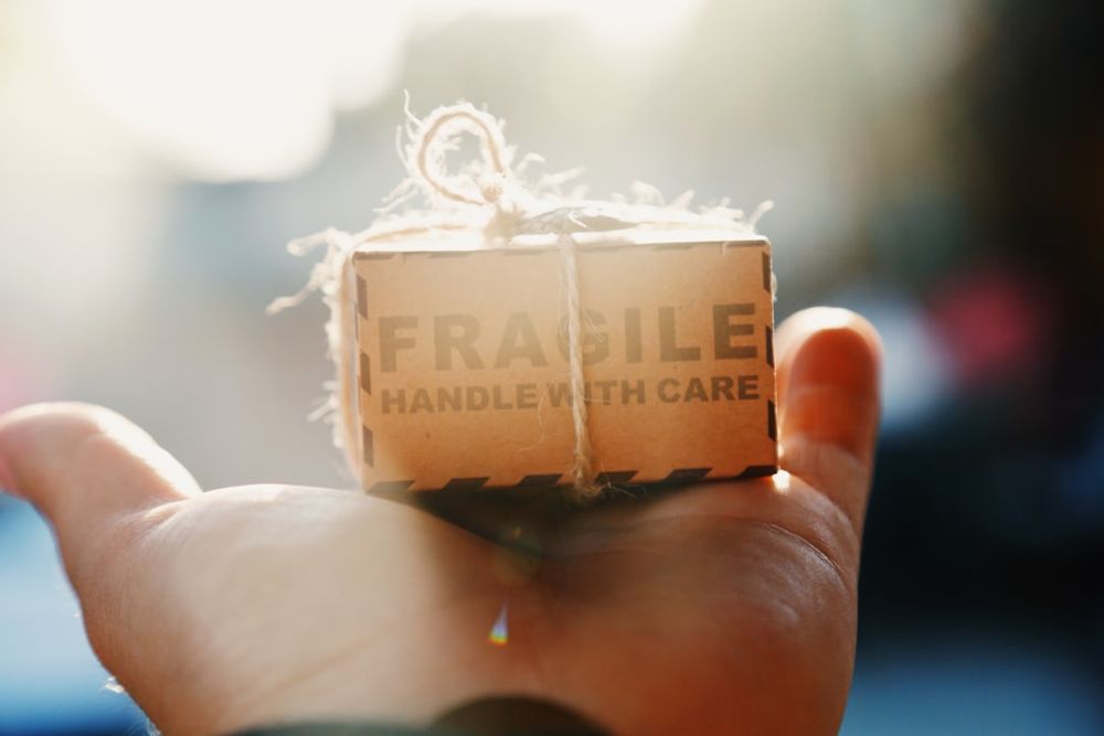 a host holding a product with overlay text showing FAQ pin: shipping fee, return policy, stock count