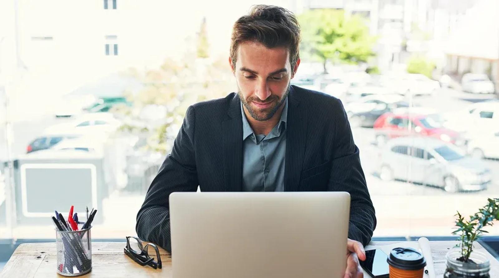 Business professional using local SEO management software on computer to optimize franchise location visibility