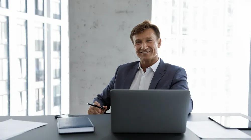 Business owner working at a computer in a professional office representing NAP consistency local SEO audit process