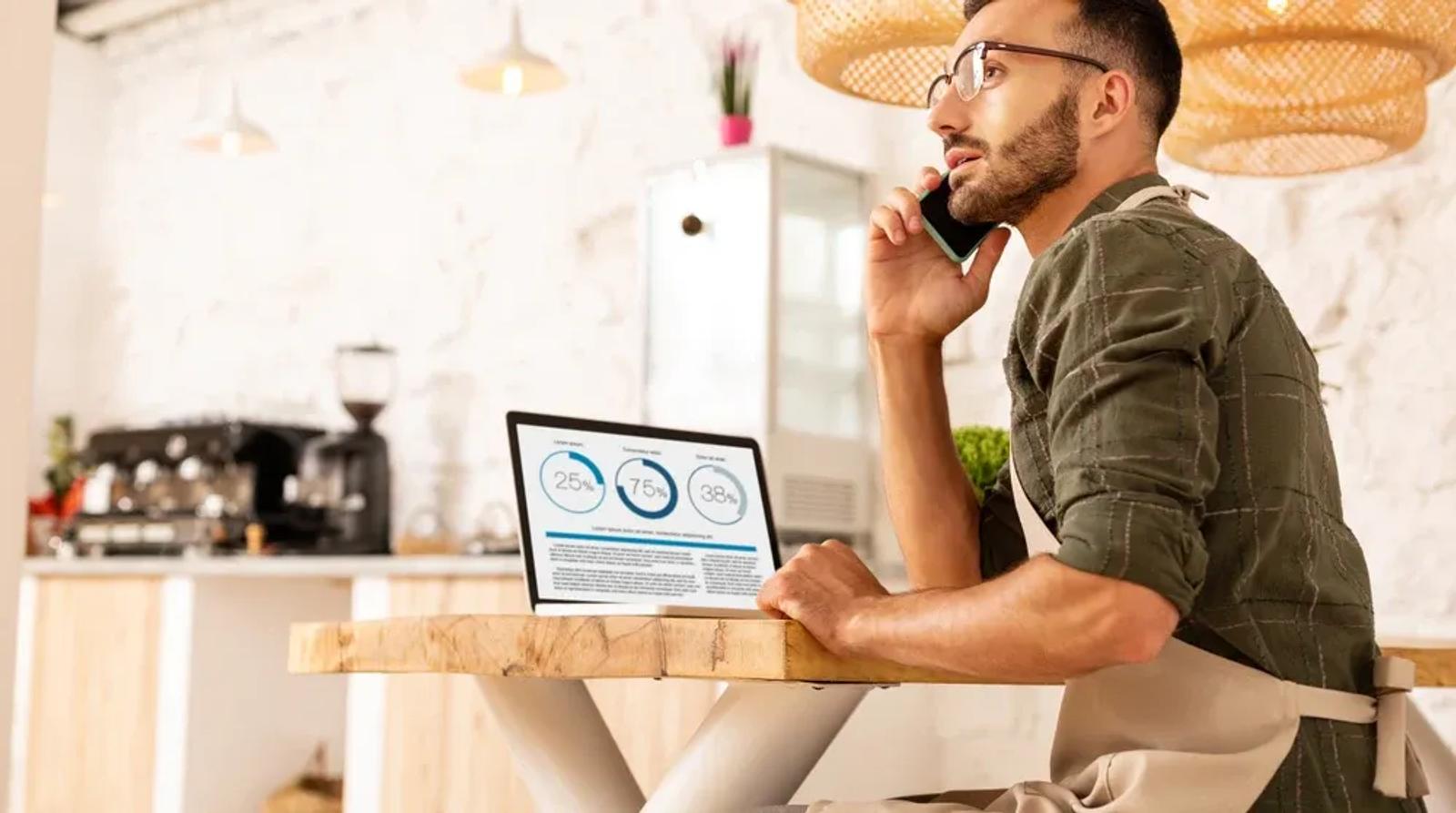 Business owner reviewing local SEO keyword strategy on a laptop at a desk