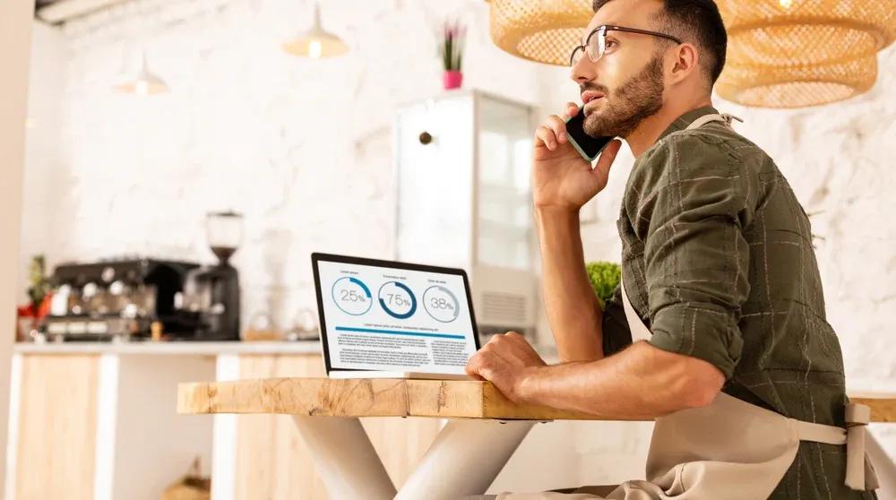Business owner reviewing local SEO keyword strategy on a laptop at a desk