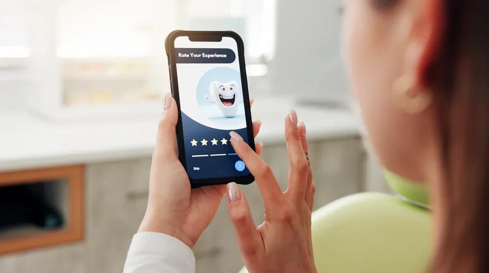 Patient leaving a Google review on smartphone after dental appointment in modern dental practice
