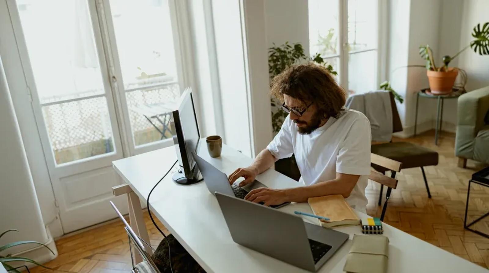 Person working on laptop analyzing link building strategy for local business SEO