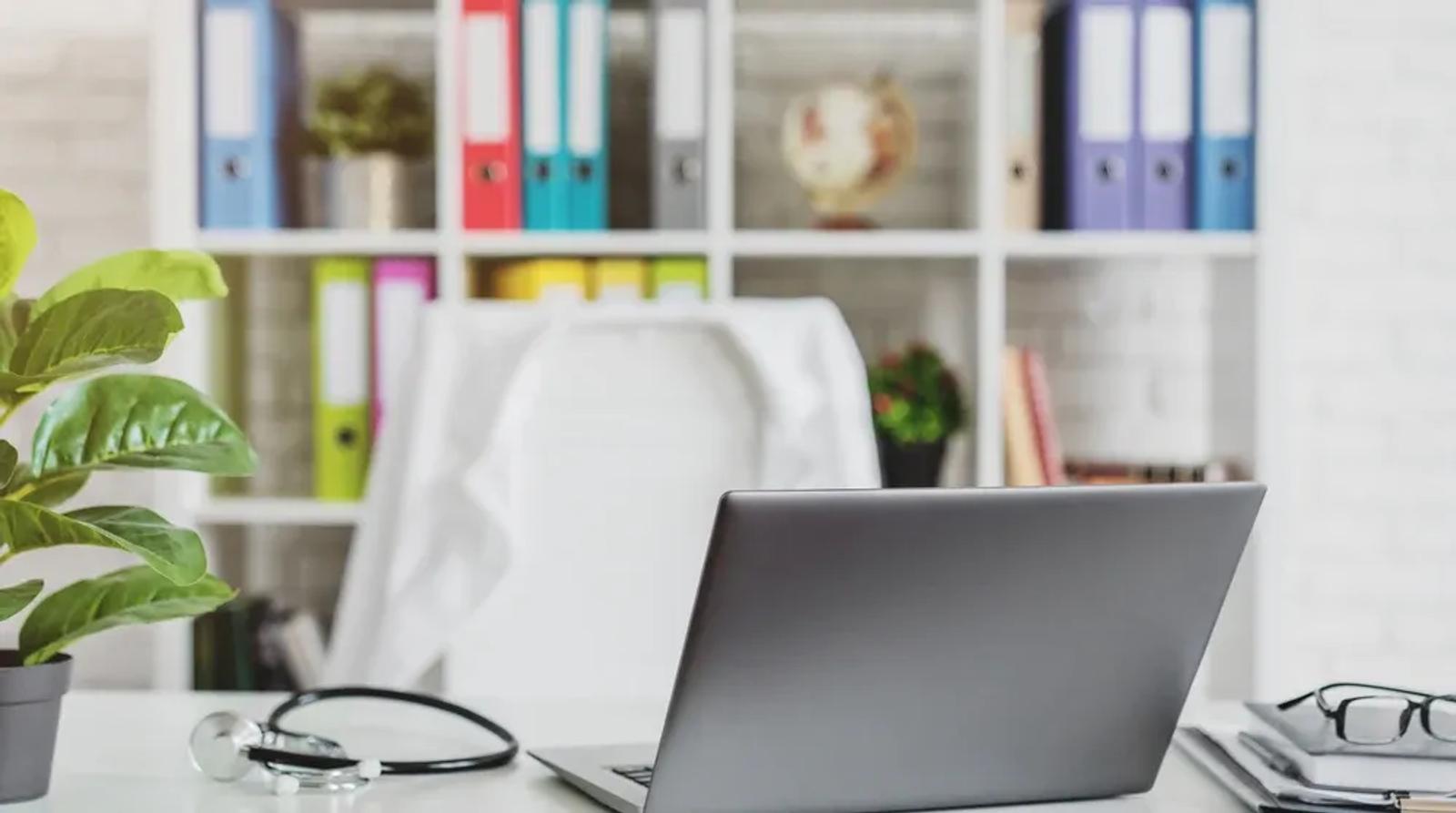Medical office desk with stethoscope and laptop representing local SEO for healthcare providers