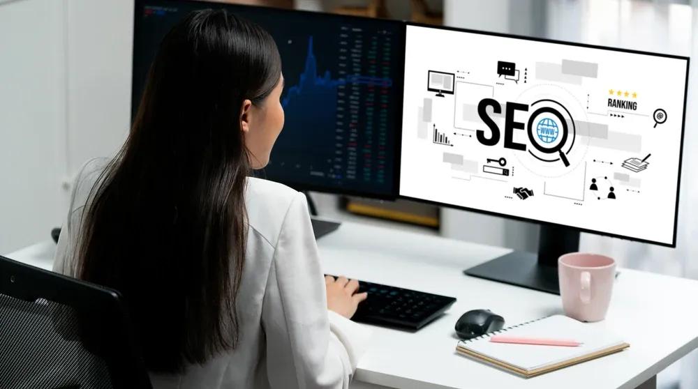 Marketing professional analyzing SEO keyword data on a computer screen