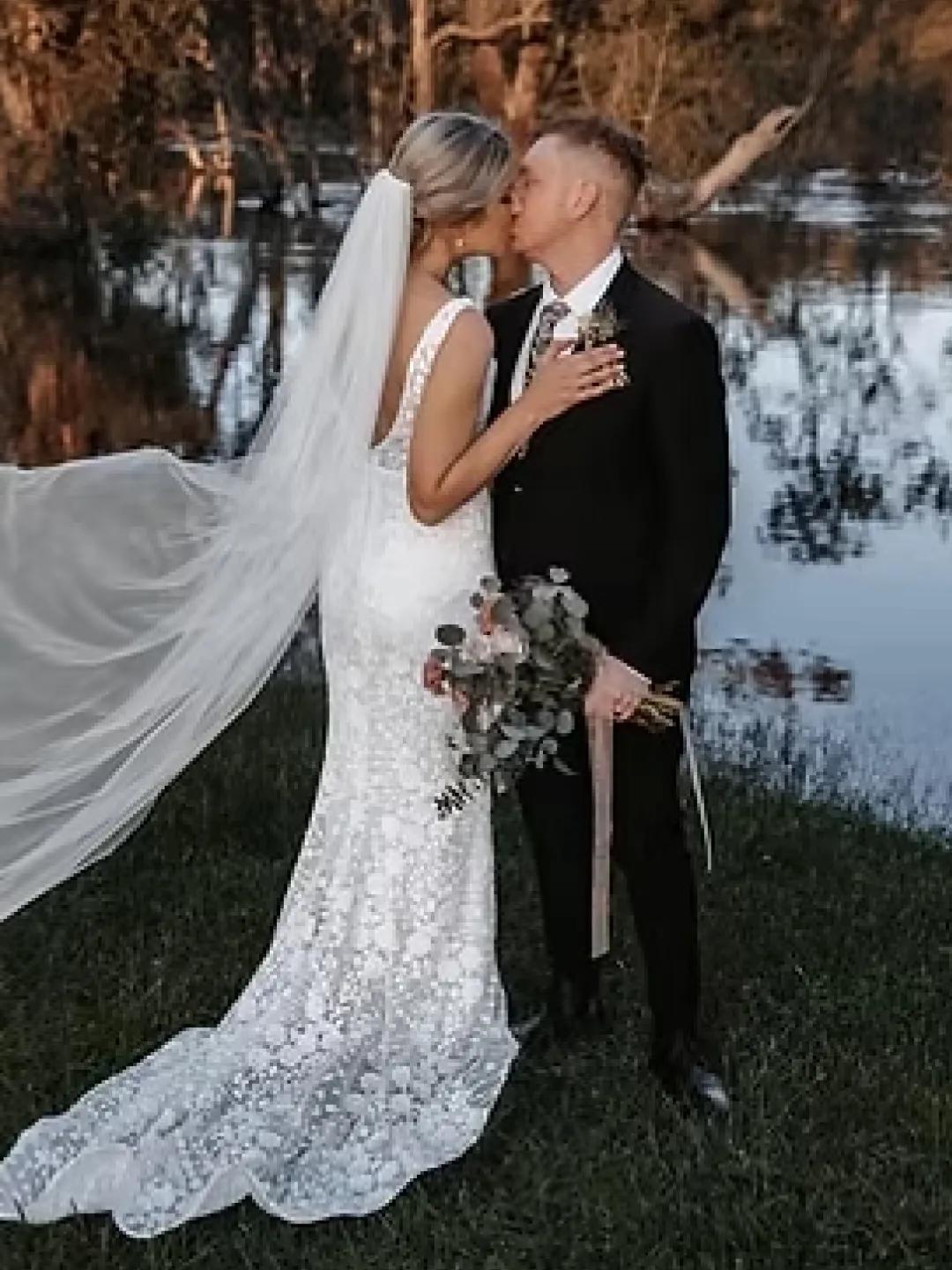 A photo of a man and woman kissing, just married.
