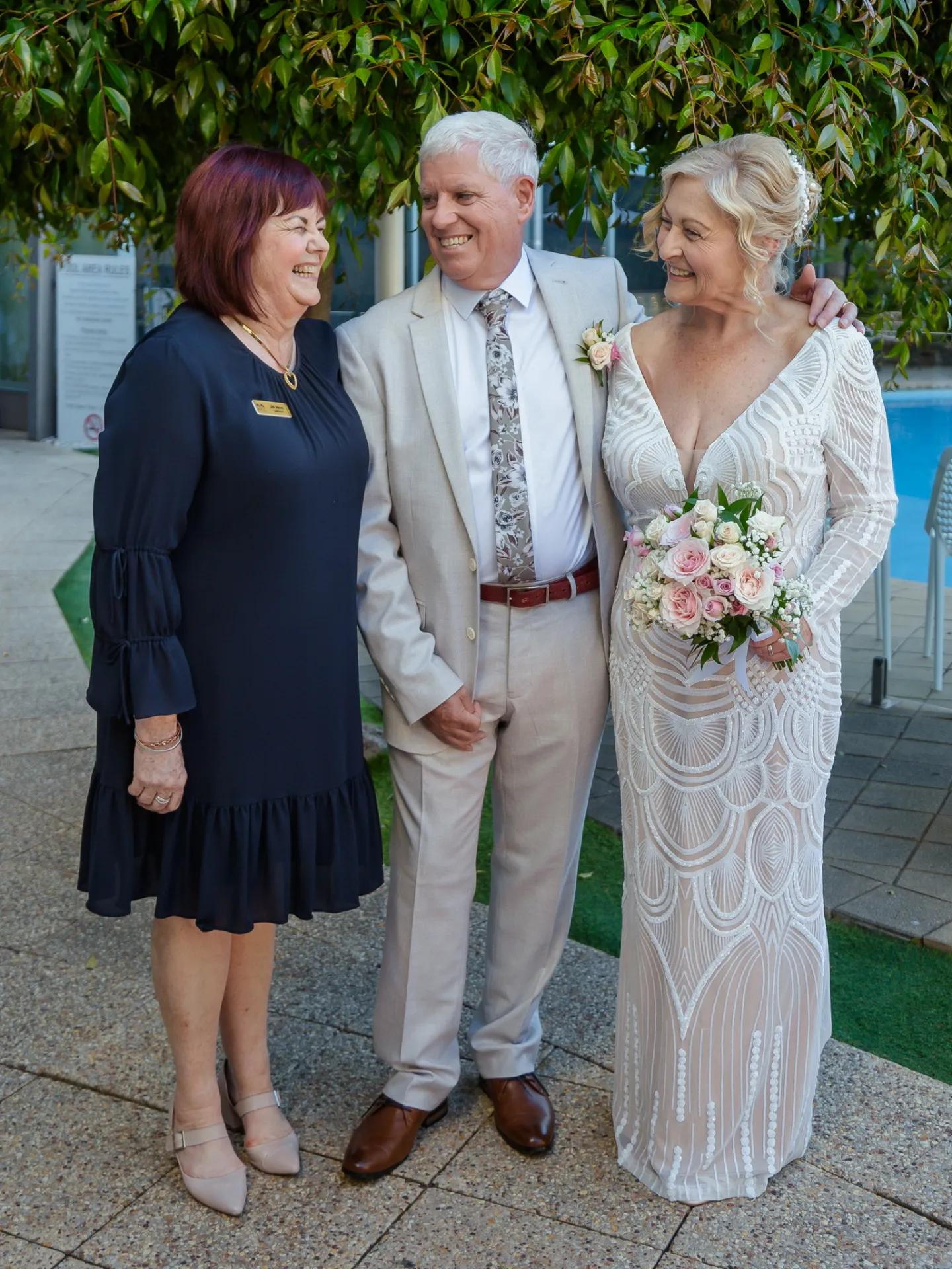 A photo of a couple standing next to Jill Venn.