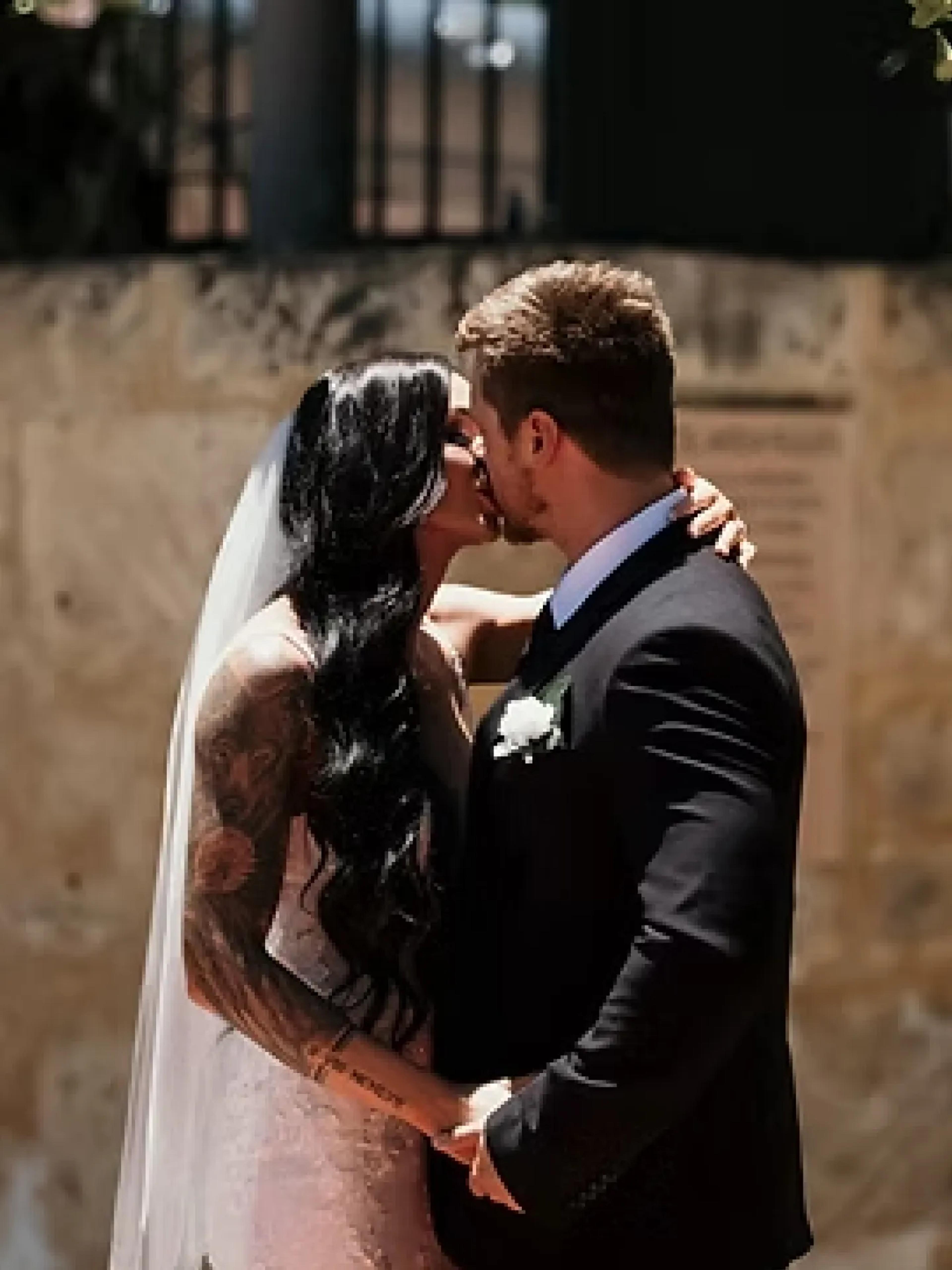 A photo of a couple kissing.