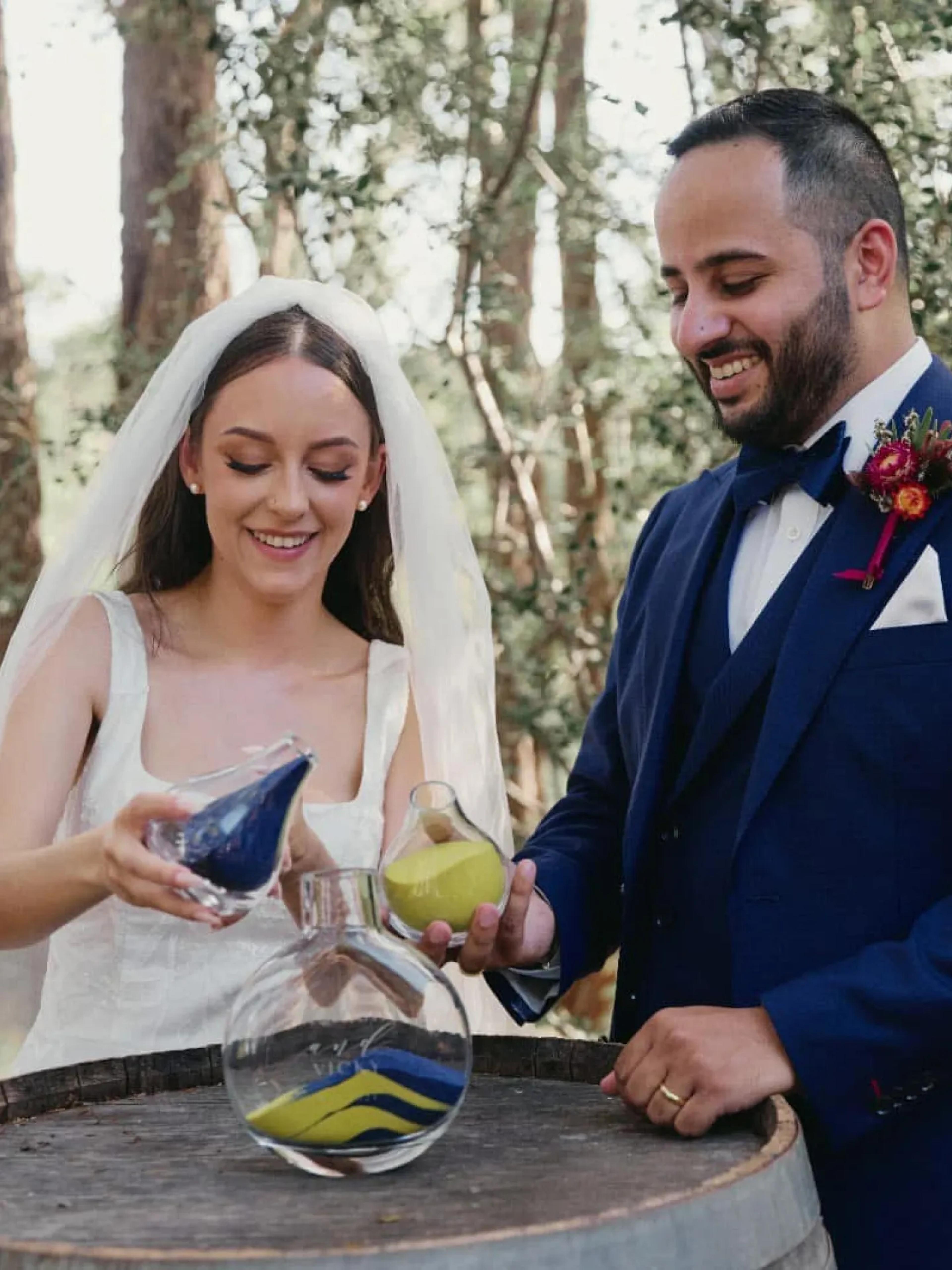 A photo of a couple performing a sand ceremony.