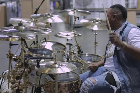 Un homme jouant de la batterie dans un hangar