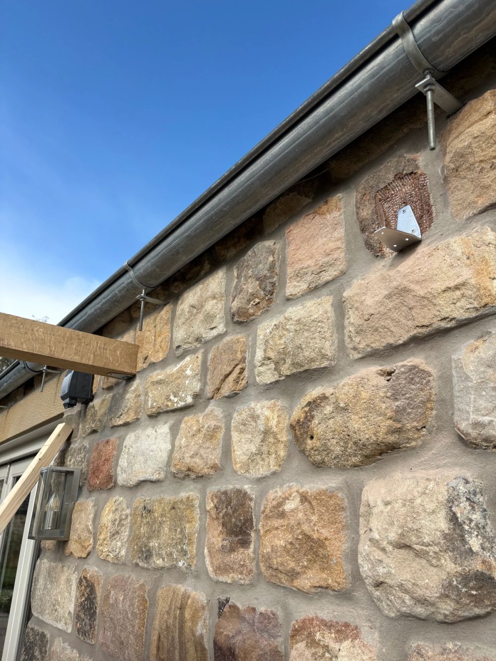Brackets fixed to wall to take cross members