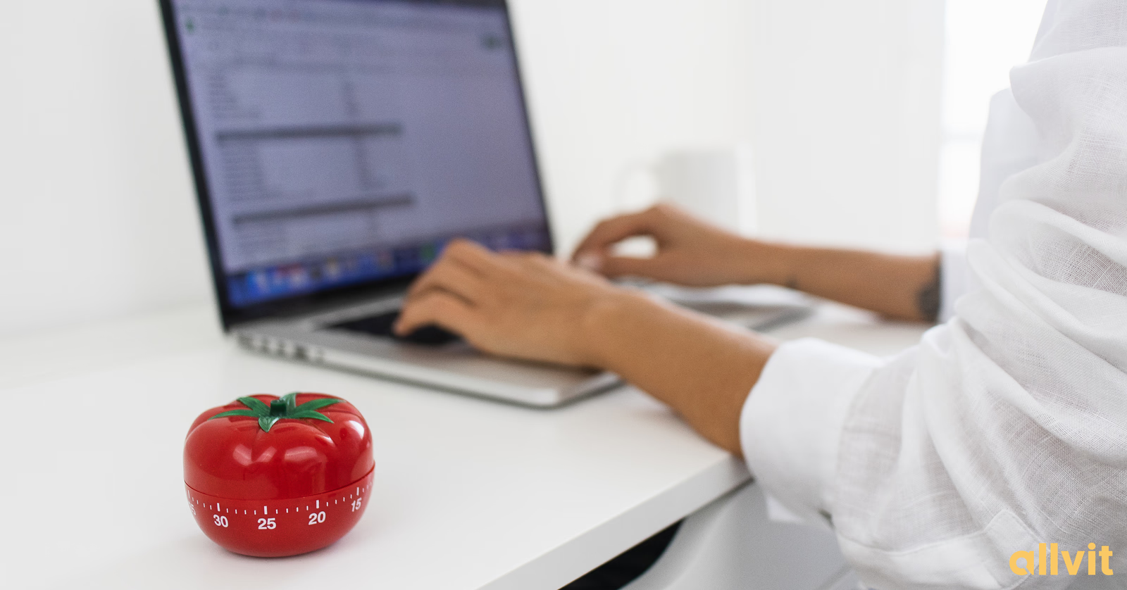 Stoppeklokke formet som en tomat foran PCen til en student. Foto.