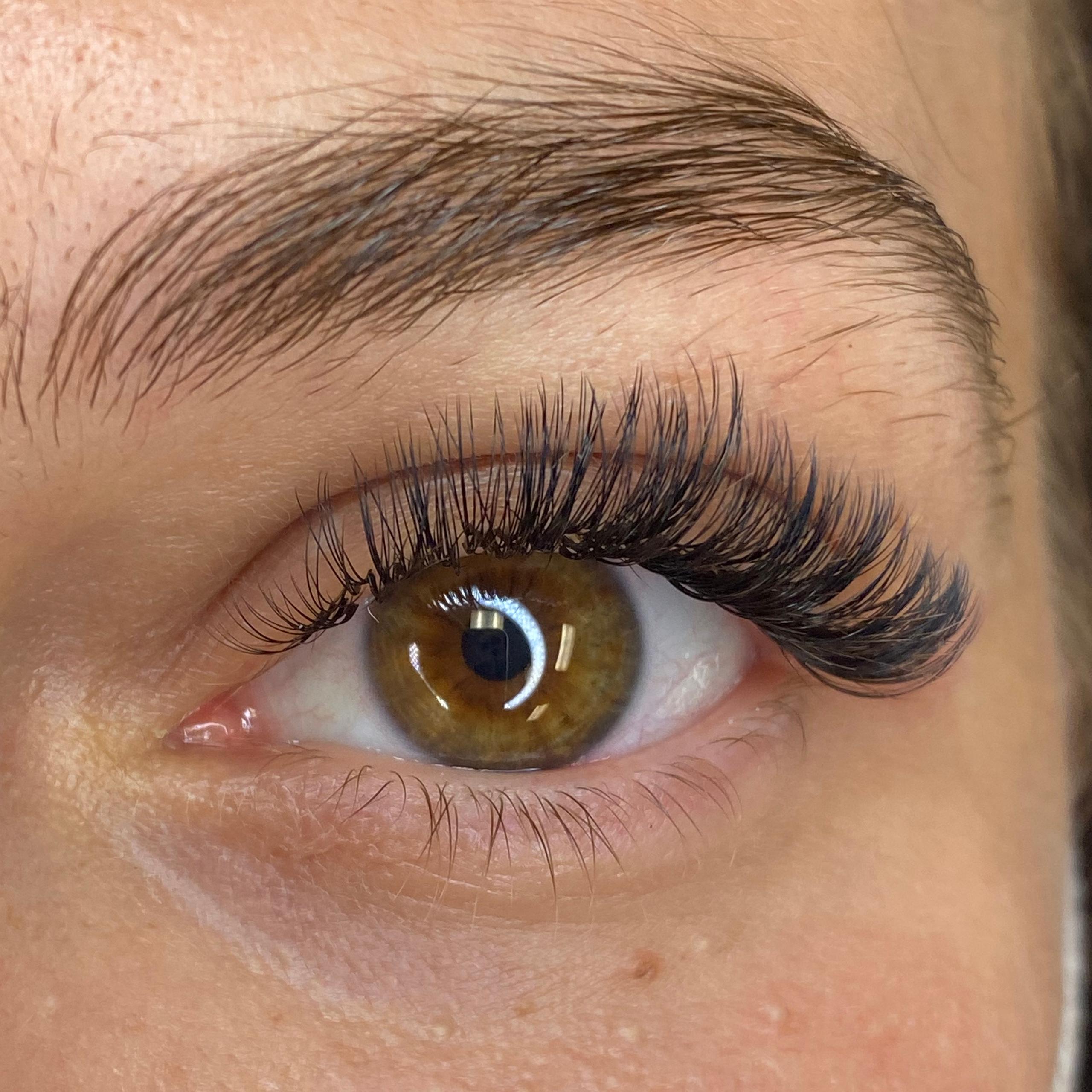 Close-up of a brown eye with voluminous eyelash extensions