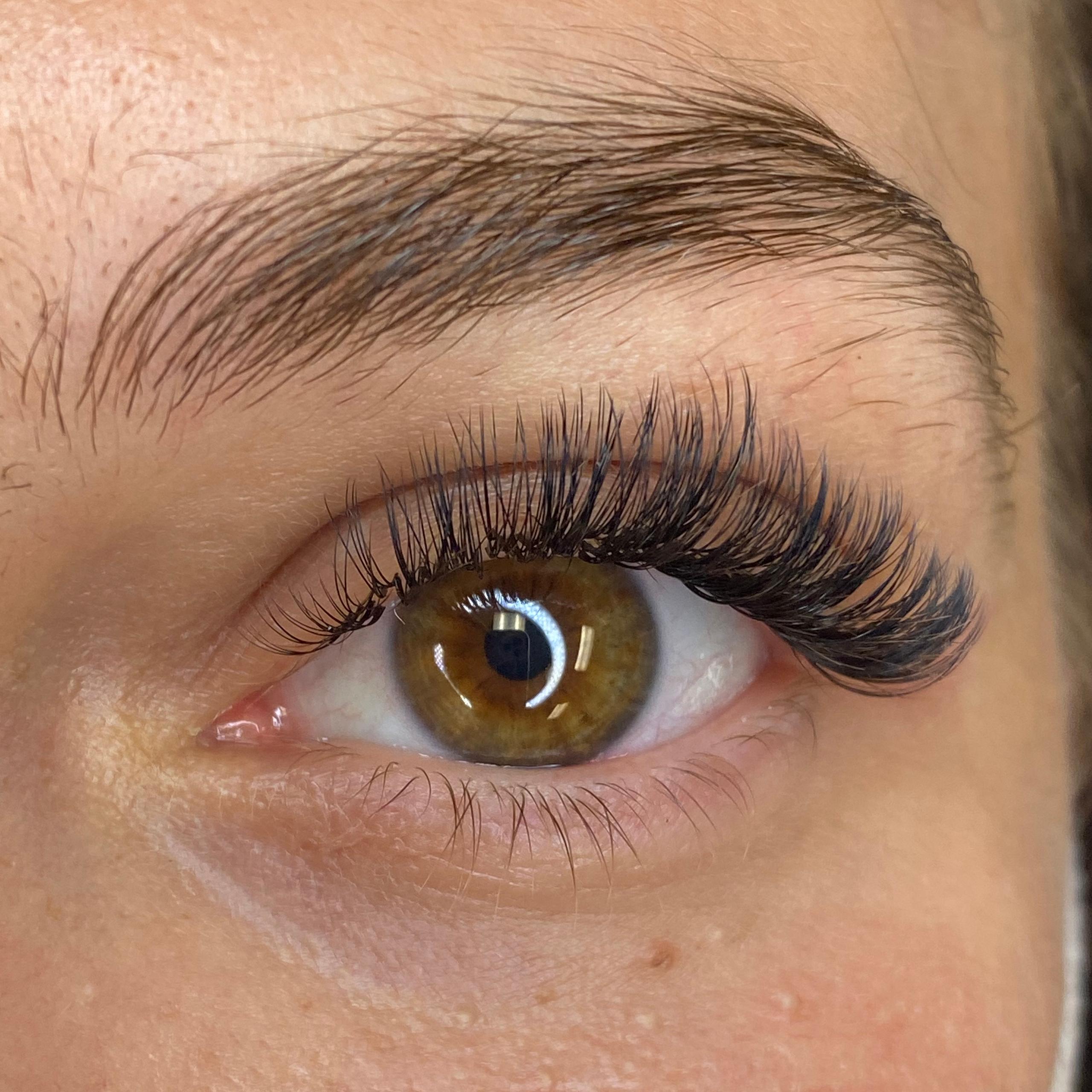 Close-up of a brown eye with voluminous eyelash extensions