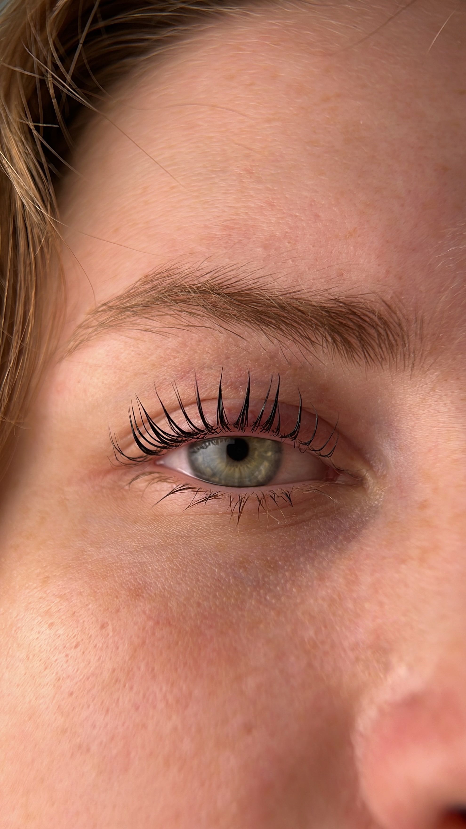 A women's lifted eyelashes close up