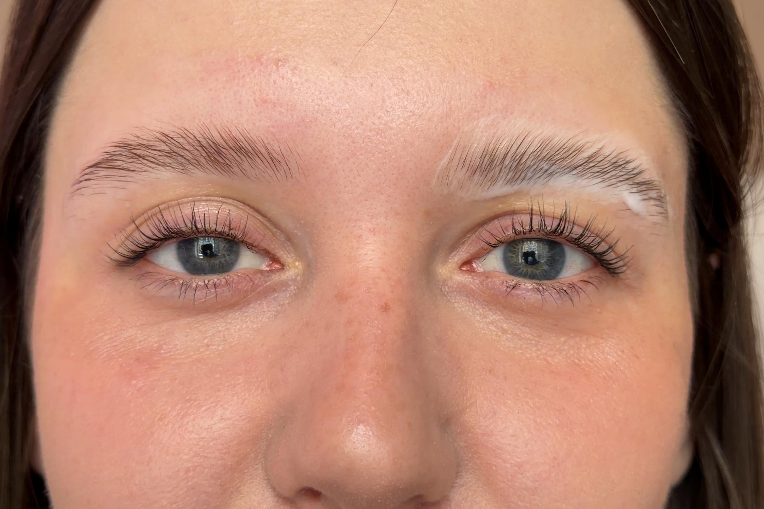 Setting cream coats a client's brushed-up eyebrows during brow lamination.